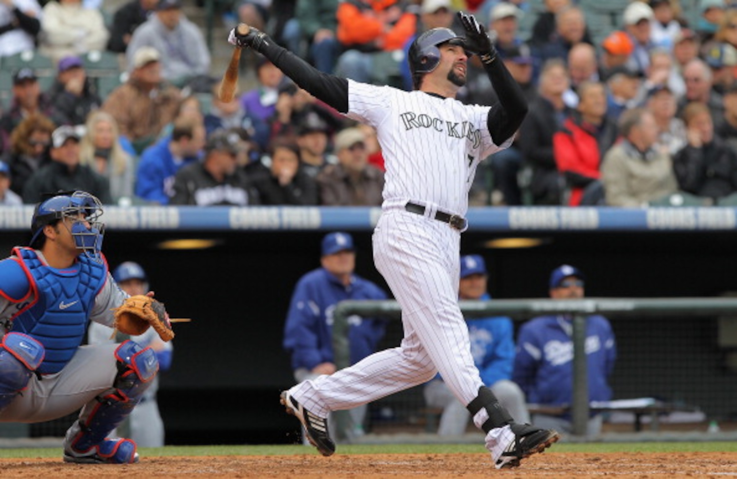 DENVER, CO - APRIL 06:  First baseman Todd Helton #17 of the Colorado Rockies watches his three run homerun off of starting pitcher Chad Billingsley #58 of the Los Angeles Dodgers to give the Rockies a 5-4 lead in the third inning at Coors Field on April