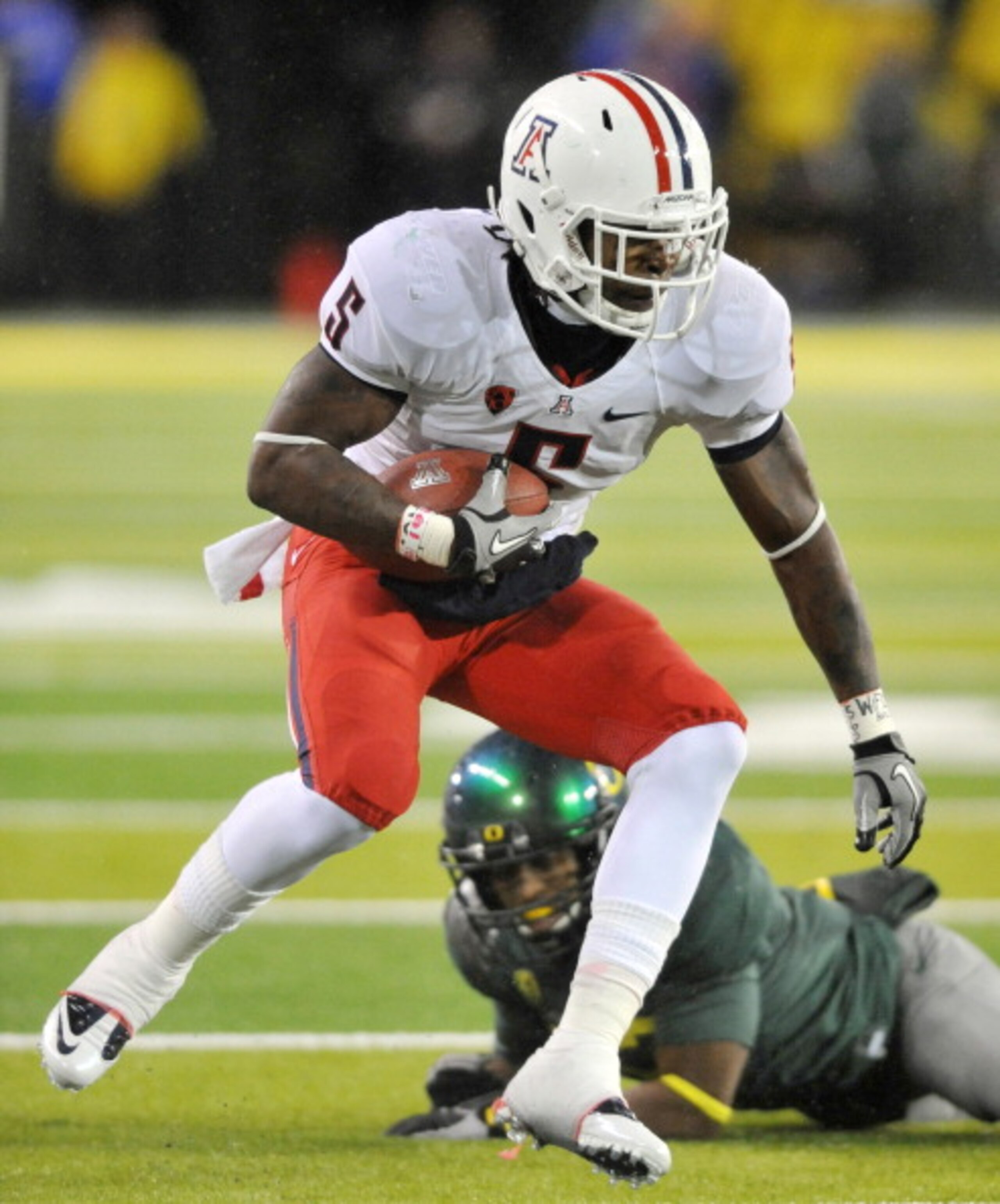 EUGENE, OR - NOVEMBER 26: Running back Nic Grigsby #5 of the Arizona Wildcats runs with the ball in the second quarter of the game against the Oregon Ducks at Autzen Stadium on November 26, 2010 in Eugene, Oregon. (Photo by Steve Dykes/Getty Images)