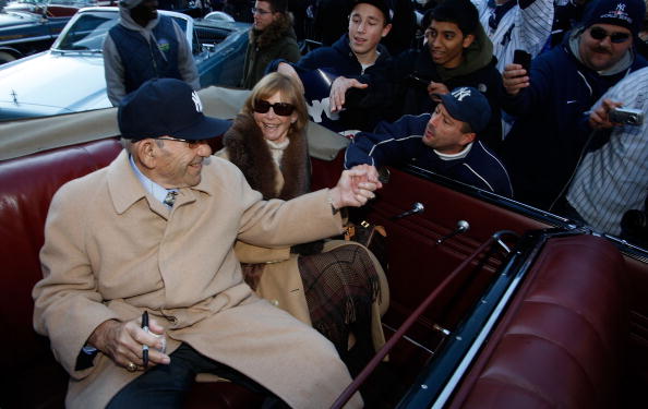 NEW YORK - NOVEMBER 06:  Former New York Yankee Yogi Berra shakes hands with a fan before the New York Yankees World Series Victory Parade on November 6, 2009 in New York, New York.  (Photo by Jared Wickerham/Getty Images)