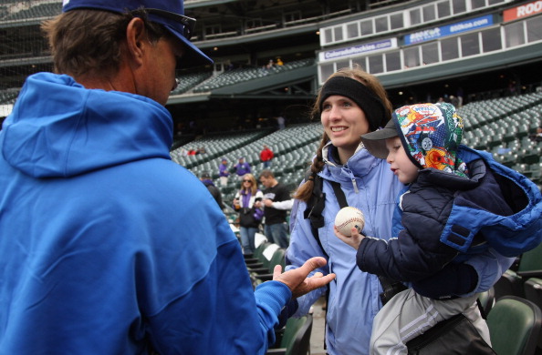 DENVER, CO - APRIL 06:  Manager Don Mattingly of the Los Angeles Dodgers signs autographs Ocea Williams and her son Jason Williams, age 3, prior to the game as the Dodgers face the Colorado Rockies host the Dodgers at Coors Field on April 6, 2011 in Denve