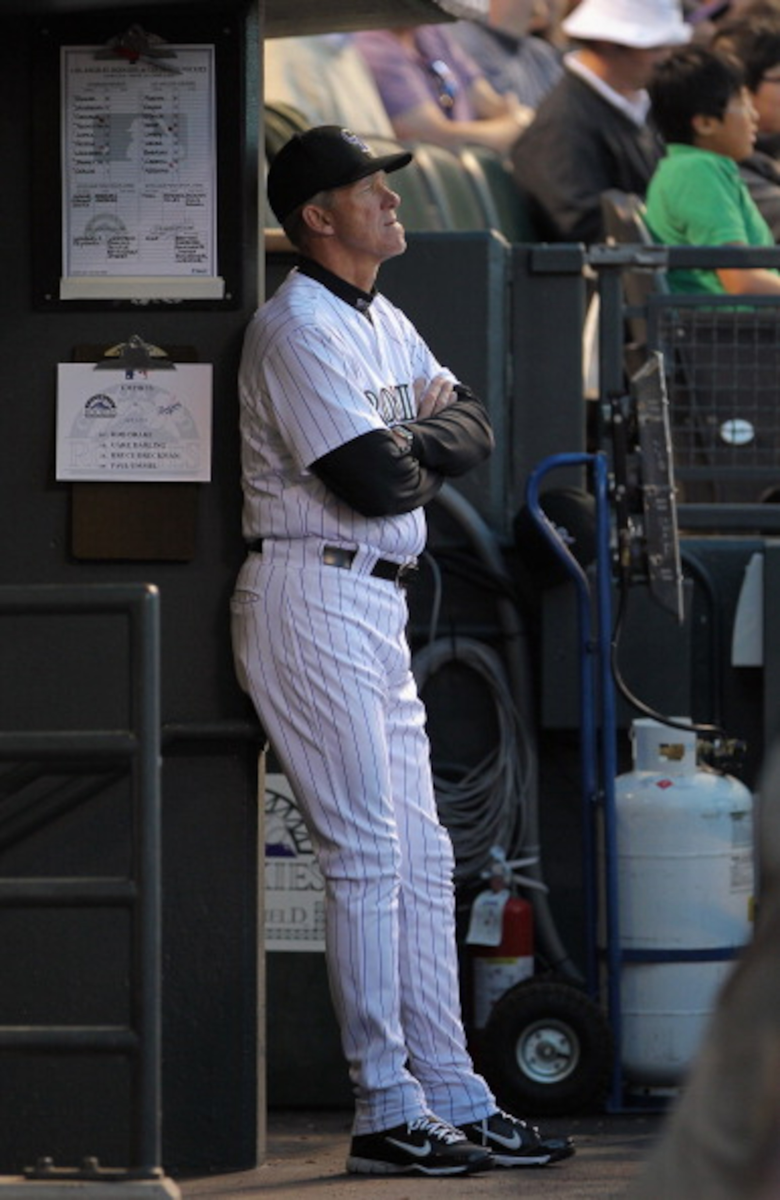 DENVER, CO - APRIL 05:  Manager Jim Tracy #4 of the Colorado Rockies oversees the action from the dugout as the Rockies defeated the Los Angeles Dodgers 3-0 at Coors Field on April 5, 2011 in Denver, Colorado.  (Photo by Doug Pensinger/Getty Images)