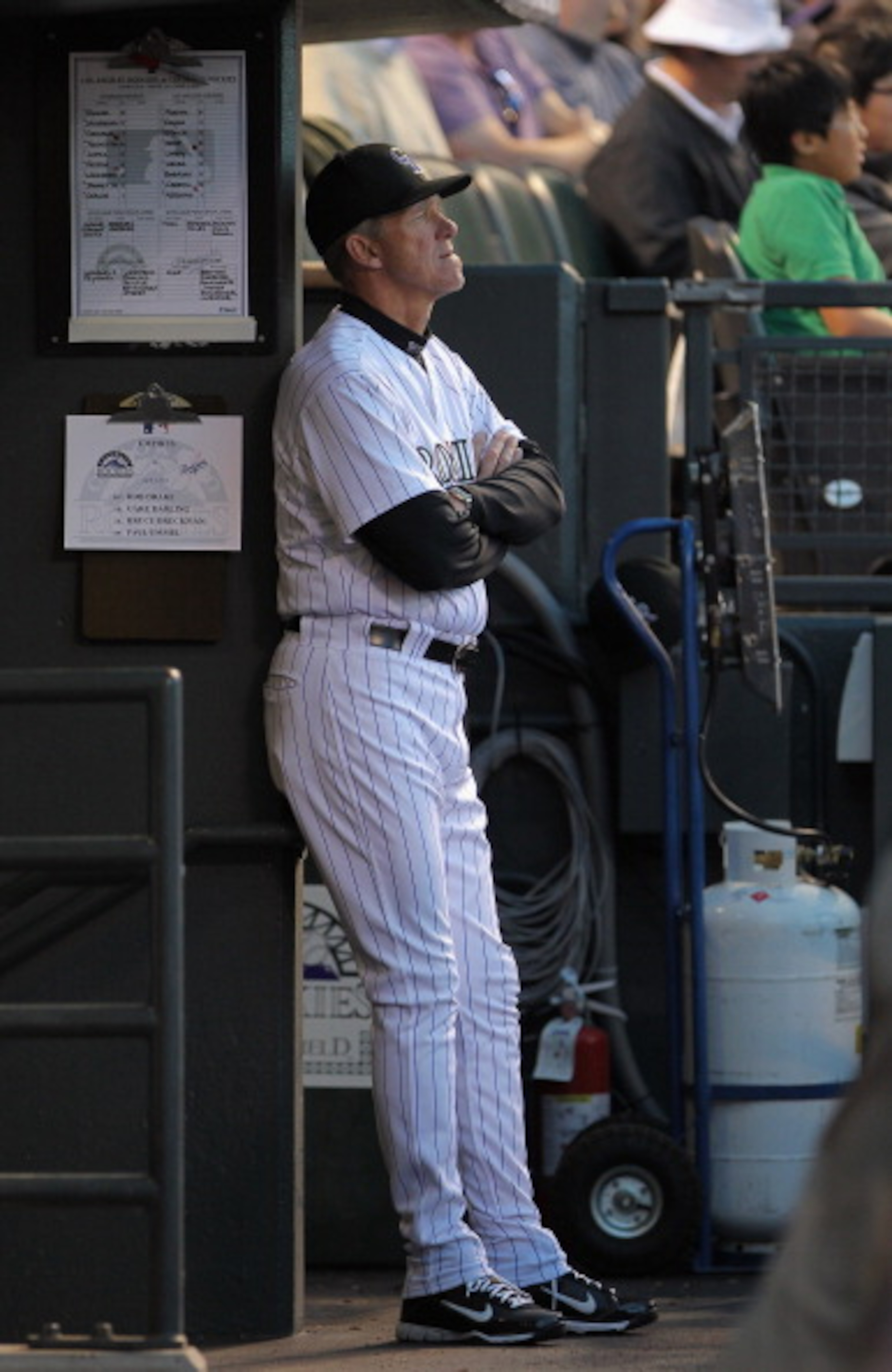 DENVER, CO - APRIL 05:  Manager Jim Tracy #4 of the Colorado Rockies oversees the action from the dugout as the Rockies defeated the Los Angeles Dodgers 3-0 at Coors Field on April 5, 2011 in Denver, Colorado.  (Photo by Doug Pensinger/Getty Images)