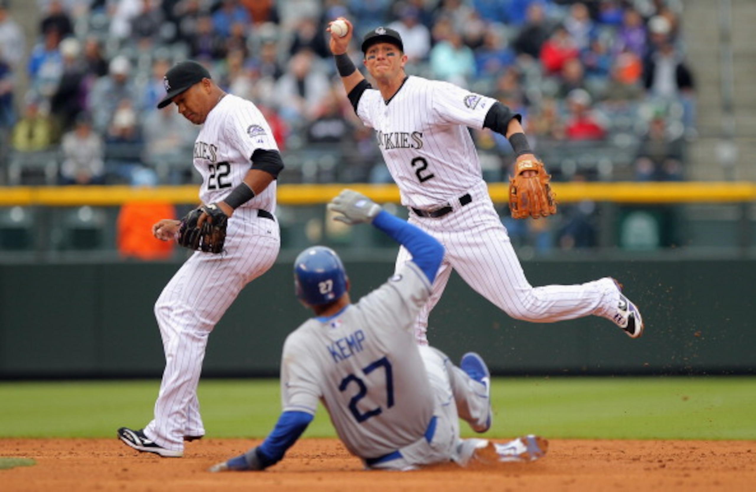 DENVER, CO - APRIL 06:  Shortstop Troy Tulowitzki #2 of the Colorado Rockies turns a double play over Matt Kemp #27 of the Los Angeles Dodgers after he fielded a ground ball by James Loney #7 of the Los Angeles Dodgers as second baseman Jose Lopez #22 of