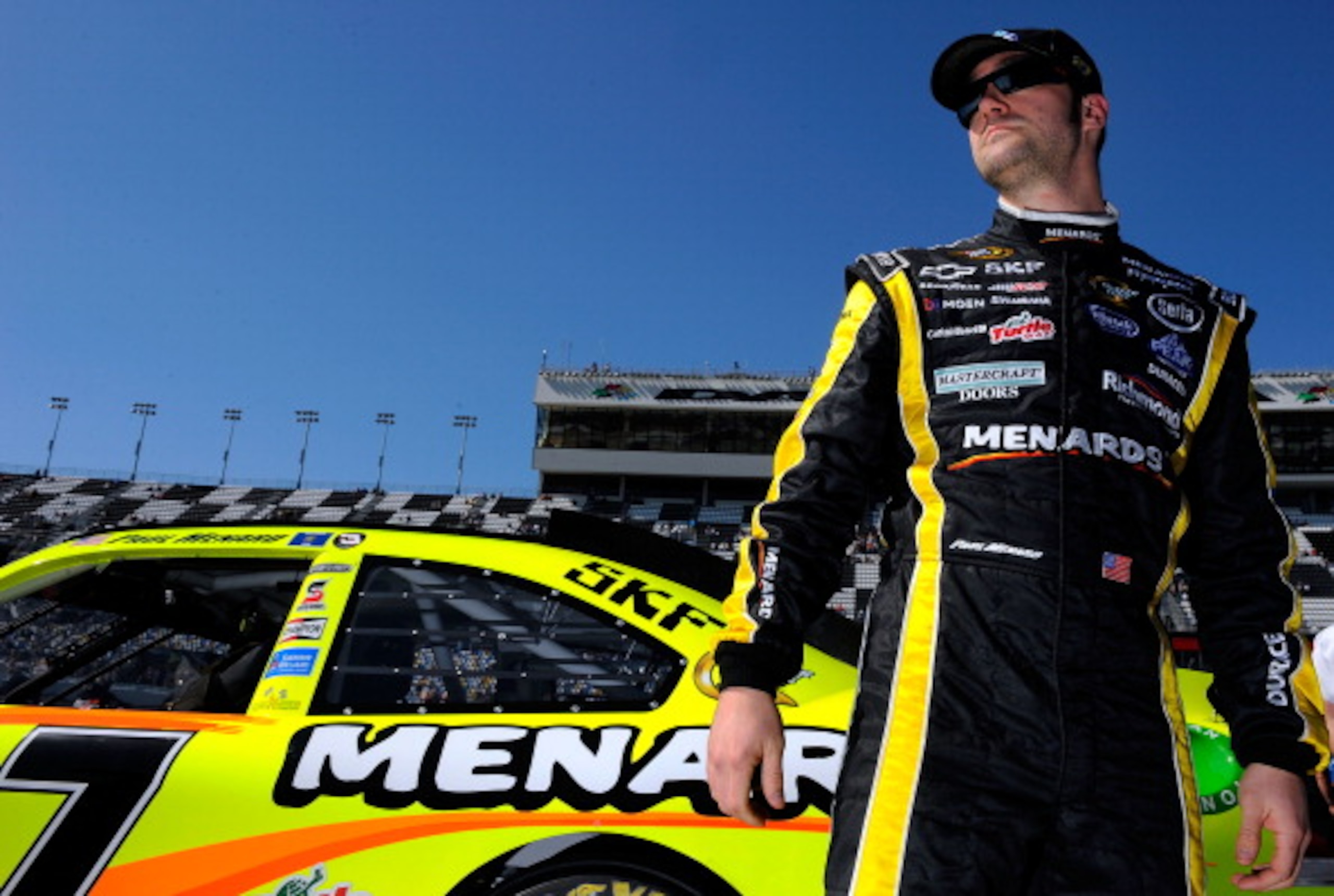 DAYTONA BEACH, FL - FEBRUARY 13:  Paul Menard, driver of the #27 Menards Chevrolet, stands on the grid during qualifying for the NASCAR Sprint Cup Series Daytona 500 at Daytona International Speedway on February 13, 2011 in Daytona Beach, Florida.  (Photo
