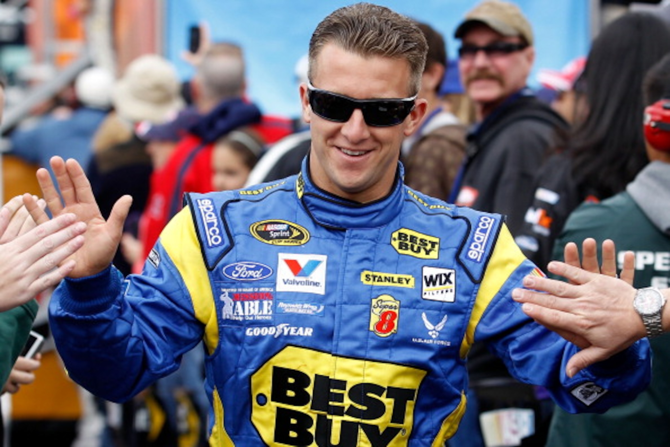 FONTANA, CA - MARCH 27:  AJ Allmendinger, driver of the #43 Best Buy Ford, greets fans during driver introductions for the NASCAR Sprint Cup Series Auto Club 400 at Auto Club Speedway on March 27, 2011 in Fontana, California.  (Photo by Todd Warshaw/Getty