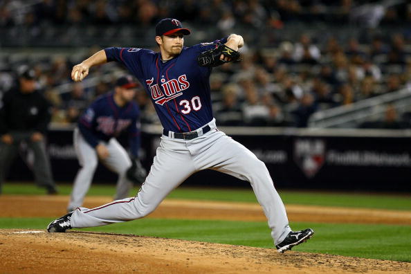 NEW YORK - OCTOBER 09:  Scott Baker #30 of the Minnesota Twins throws a pitch against the New York Yankees during Game Three of the ALDS part of the 2010 MLB Playoffs at Yankee Stadium on October 9, 2010 in the Bronx borough of New York City.  (Photo by A