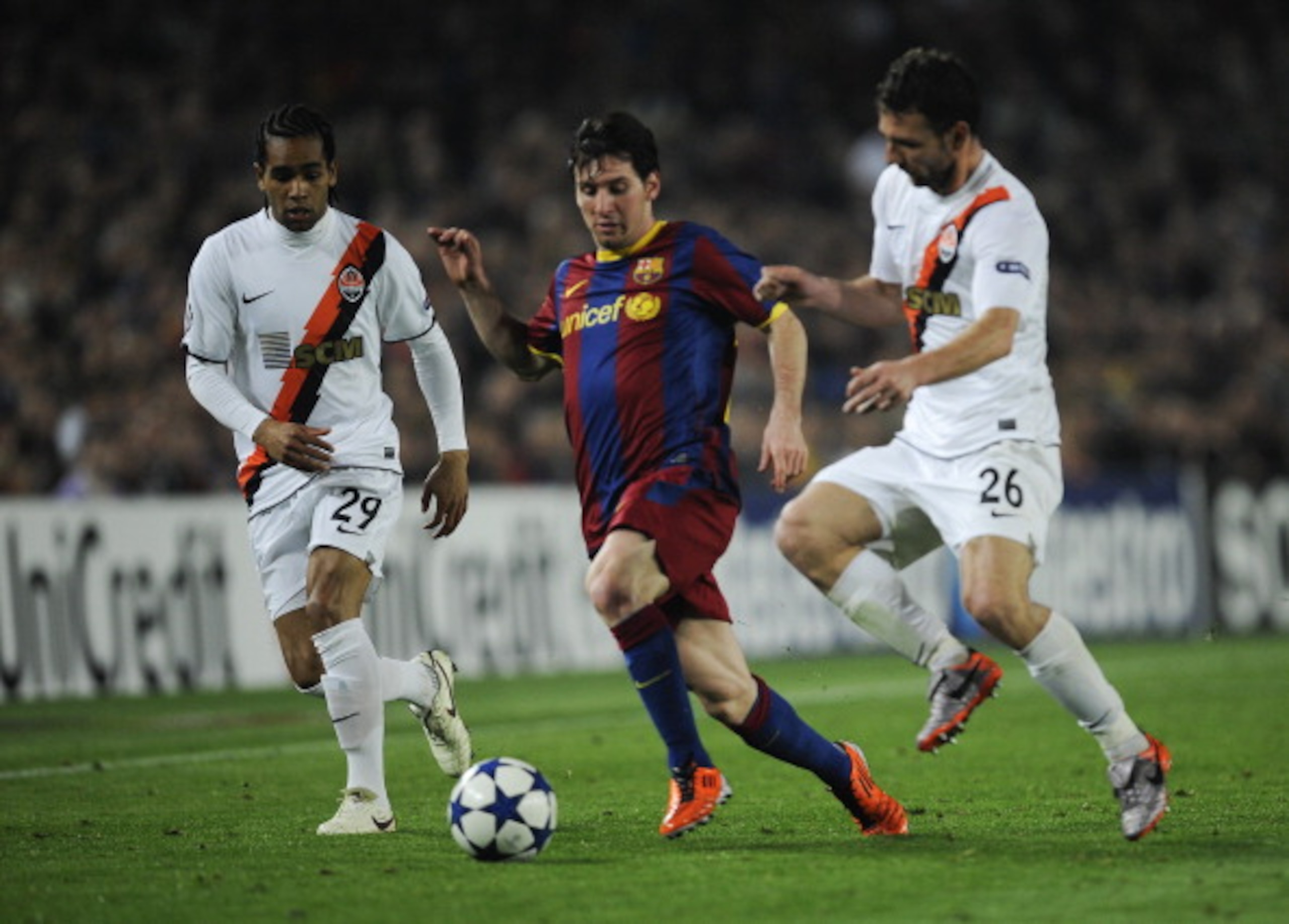 BARCELONA, SPAIN - APRIL 06:  Lionel Messi of FC Barcelona (C) fights for the ball against Alex Teixeira (L) and Razvan Rat of Shakhtar Donetsk during the UEFA Champions League quarter final first leg match between Barcelona and Shakhtar Donetsk at the Ca