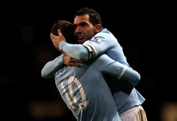 MANCHESTER, ENGLAND - JANUARY 15: Carlos Tevez of Manchester City celebrates scoring his team's fourth goal with team mate Edin Dzeko during the Barclays Premier League match between Manchester City and Wolverhampton Wanderers at the City of Manchester S