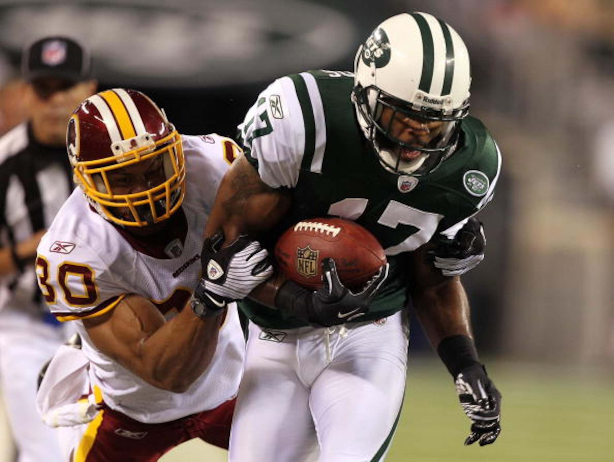 EAST RUTHERFORD, NJ - AUGUST 27:  Braylon Edwards #17 of the New York Jets is tackled by LaRon Landry #30 of the Washington Redskins  during their preseason game on August 27, 2010 at the New Meadowlands Stadium  in East Rutherford, New Jersey.  (Photo by