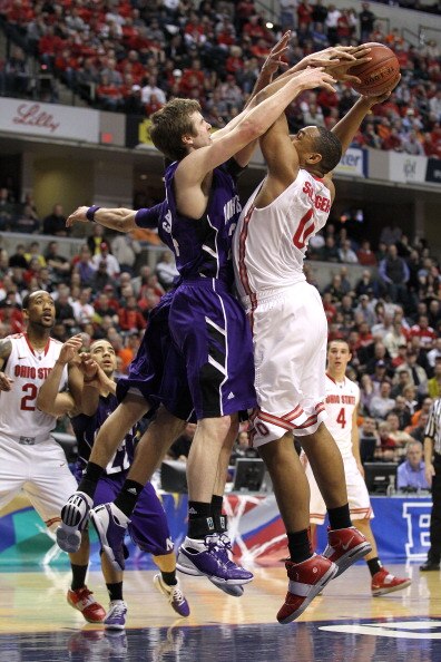 INDIANAPOLIS, IN - MARCH 11:  Jared Sullinger #0 of the Ohio State Buckeyes is fouled on a shot attempt by John Shurna #24 of the Northwestern Wildcats during the quarterfinals of the 2011 Big Ten Men's Basketball Tournament at Conseco Fieldhouse on March
