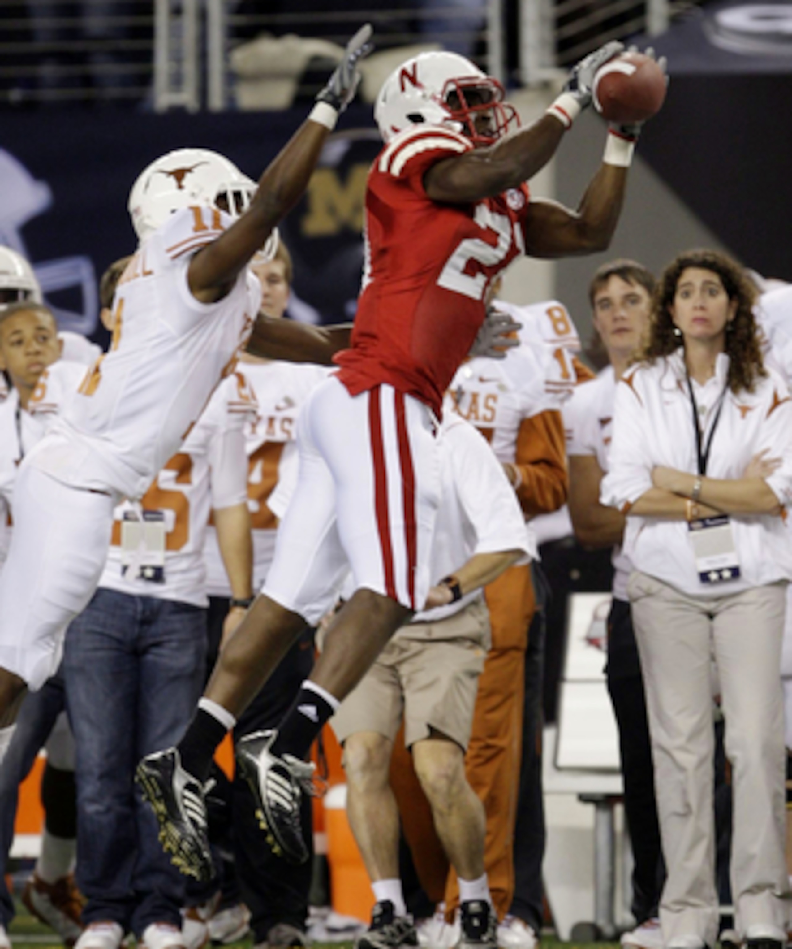 ARLINGTON, TX - DECEMBER 5:  Prince Amukamara #21 of the Nebraska Cornhuskers catches the ball for an interception in the first quarter in front of James Kirkendoll #11 of the Texas Longhorns at Cowboys Stadium on December 5, 2009 in Arlington, Texas. (Ph