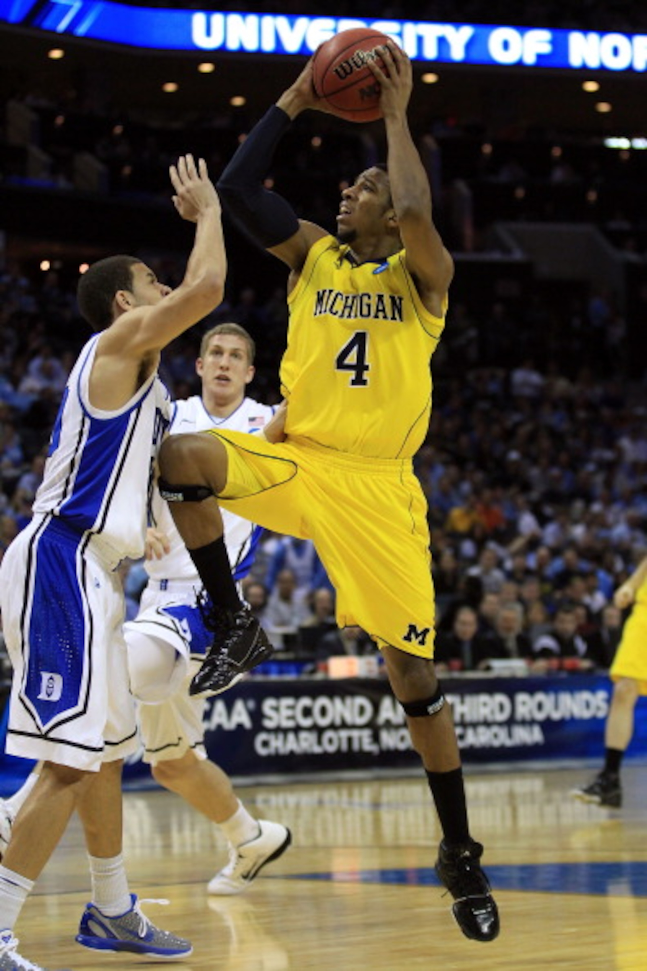 CHARLOTTE, NC - MARCH 20: Darius Morris #4 of the Michigan Wolverines goes up for a shot against Seth Curry #30 of the Duke Blue Devils during the third round of the 2011 NCAA men's basketball tournament at Time Warner Cable Arena on March 20, 2011 in Ch CHARLOTTE, NC - MARCH 20: Darius Morris #4 of the Michigan Wolverines goes up for a shot against Seth Curry #30 of the Duke Blue Devils during the third round of the 2011 NCAA men's basketball tournament at Time Warner Cable Arena on March 20, 2011 in Ch