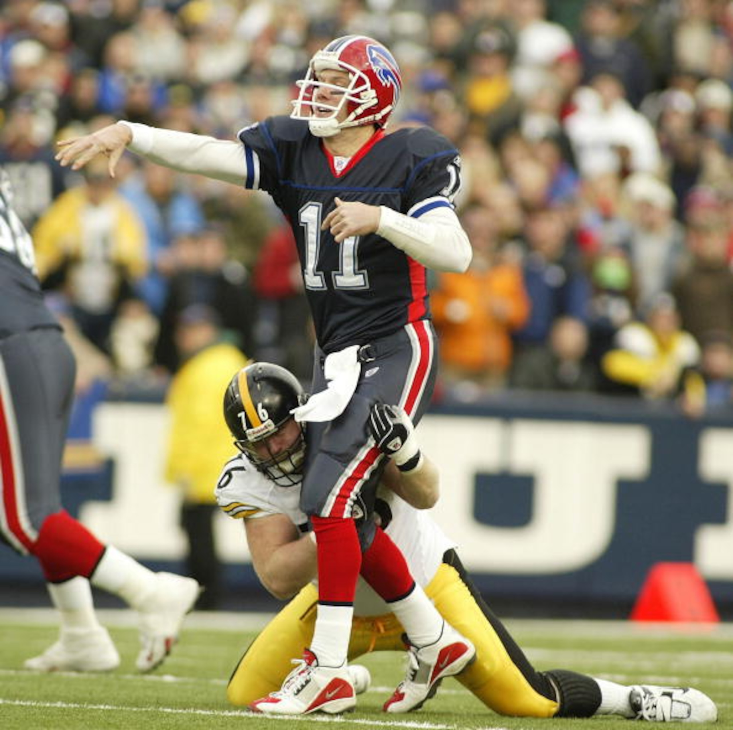 ORCHARD PARK, NY - JANUARY 2:  Drew Bledsoe #11 of the Buffalo Bills gets a pass off as Chris Hoke #76 of the Pittsburgh Steelers tries to drag him down January 2, 2005 at Ralph Wilson Stadium in Orchard Park, New York. The Steelers defeated the Bills 29-