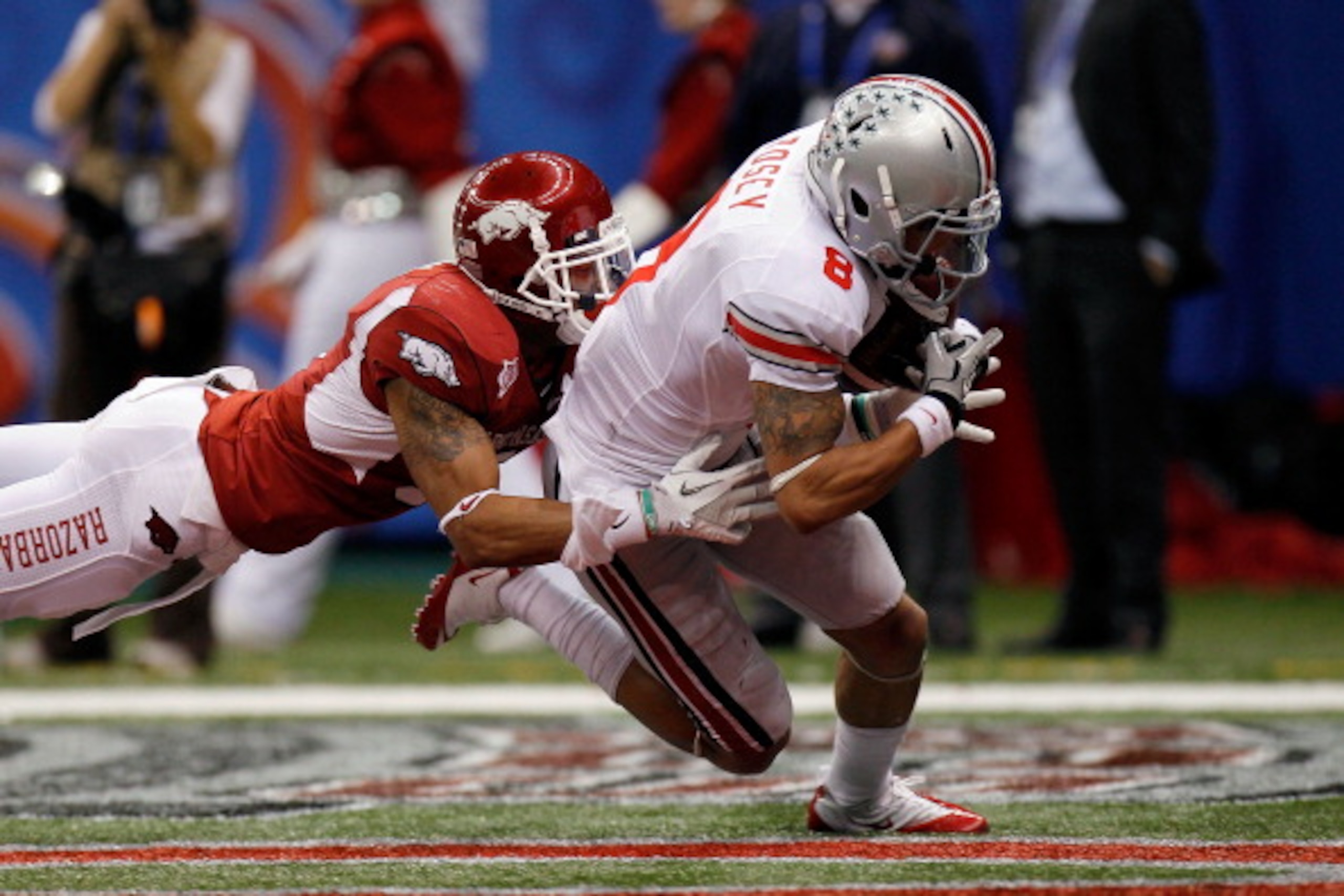 NEW ORLEANS, LA - JANUARY 04: DeVier Posey #8 of the Ohio State Buckeyes catches a 43-yard touchdown catch against Tramain Thomas #5 of the Arkansas Razorbacks in the second quarter during the Allstate Sugar Bowl at the Louisiana Superdome on January 4, NEW ORLEANS, LA - JANUARY 04: DeVier Posey #8 of the Ohio State Buckeyes catches a 43-yard touchdown catch against Tramain Thomas #5 of the Arkansas Razorbacks in the second quarter during the Allstate Sugar Bowl at the Louisiana Superdome on January 4,
