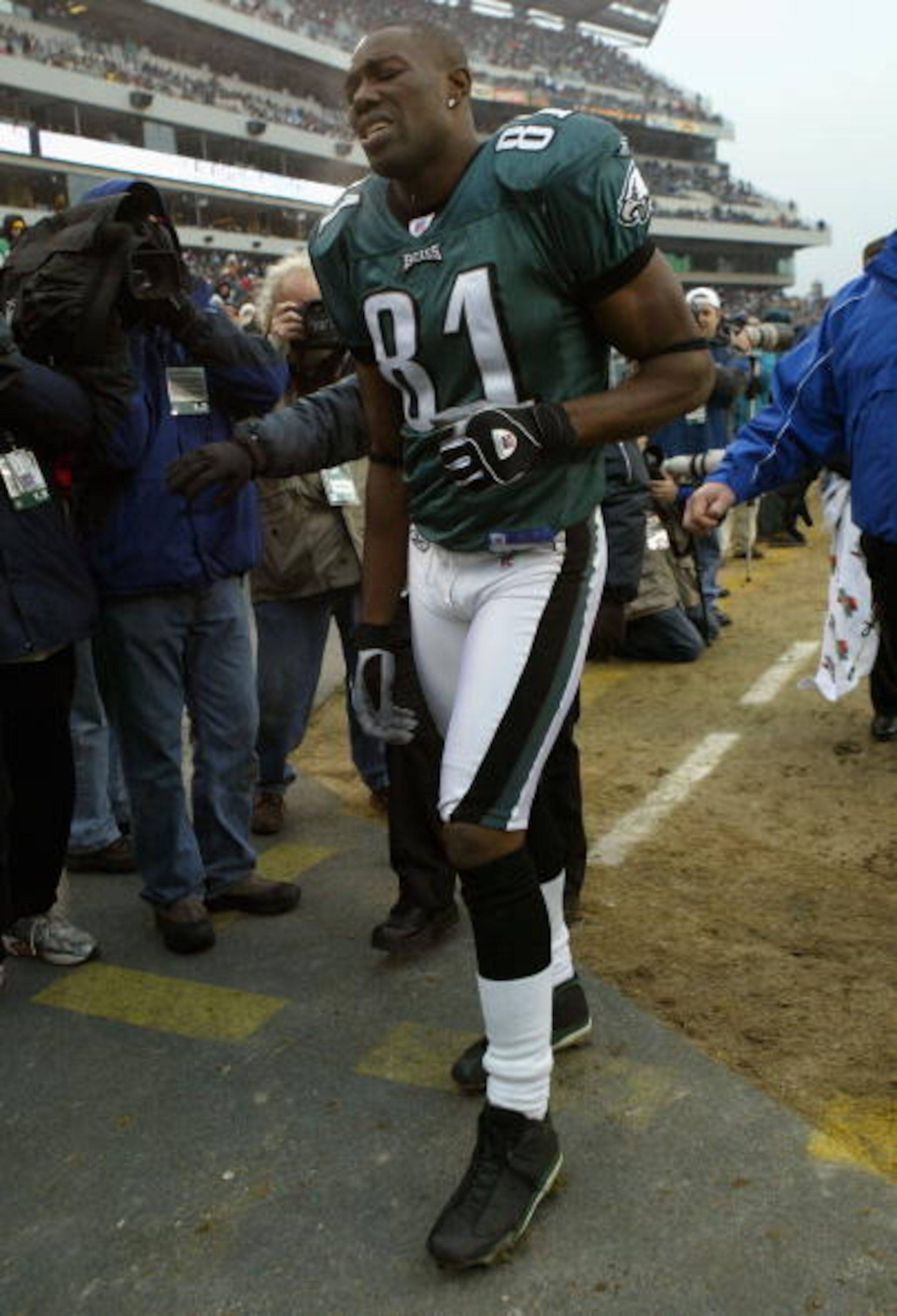 PHILADELPHIA - DECEMBER 19:  Terrell Owens #81 of the Philadelphia Eagles leaves the field in the third quarter after spraining his right ankle against the Dallas Cowboys as the Eagles defeated the Cowboys 12-7 during NFL action at Lincoln Financial Field