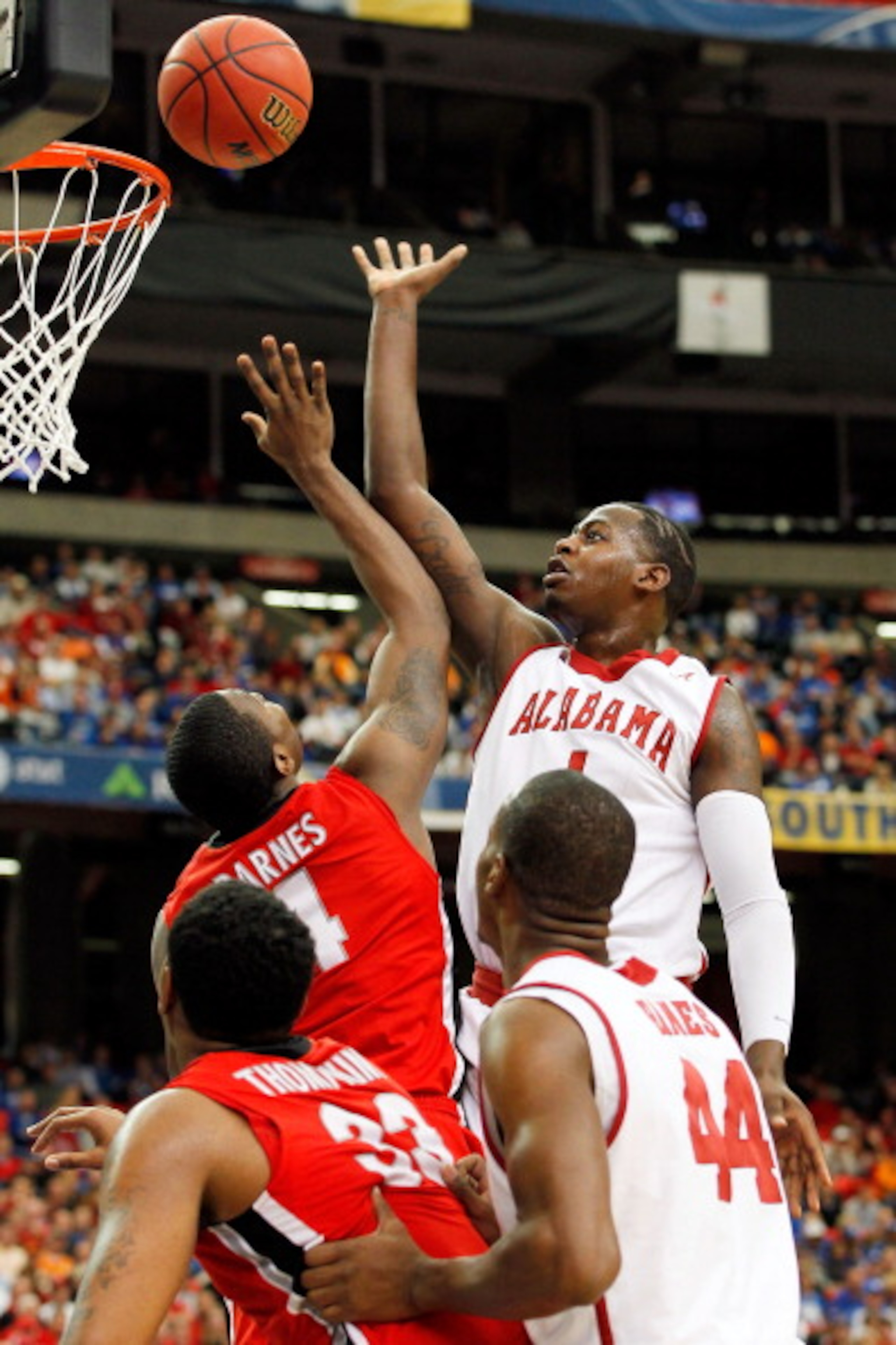 ATLANTA, GA - MARCH 11: JaMychal Green #1 of the Alabama Crimson Tide shoots over Chris Barnes #4 of the Georgia Bulldogs during the quarterfinals of the SEC Men's Basketball Tournament at Georgia Dome on March 11, 2011 in Atlanta, Georgia. (Photo by Kev ATLANTA, GA - MARCH 11: JaMychal Green #1 of the Alabama Crimson Tide shoots over Chris Barnes #4 of the Georgia Bulldogs during the quarterfinals of the SEC Men's Basketball Tournament at Georgia Dome on March 11, 2011 in Atlanta, Georgia. (Photo by Kev