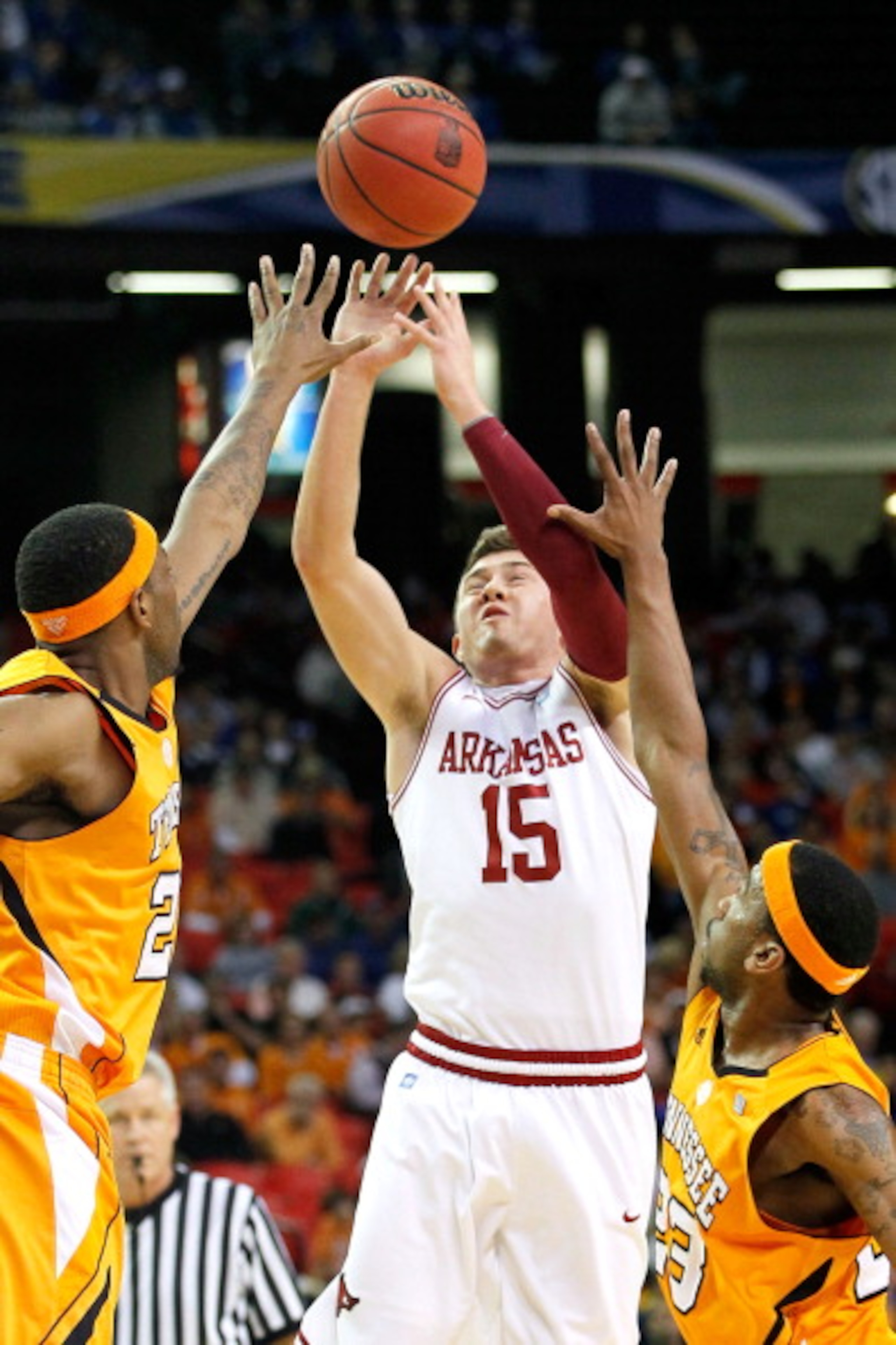 ATLANTA, GA - MARCH 10: Rotnei Clarke #15 of the Arkansas Razorbacks shoots against Kenny Hall #20 and Cameron Tatum #23 of the Tennessee Volunteers during the first round of the SEC Men's Basketball Tournament at the Georgia Dome on March 10, 2011 in At ATLANTA, GA - MARCH 10: Rotnei Clarke #15 of the Arkansas Razorbacks shoots against Kenny Hall #20 and Cameron Tatum #23 of the Tennessee Volunteers during the first round of the SEC Men's Basketball Tournament at the Georgia Dome on March 10, 2011 in At