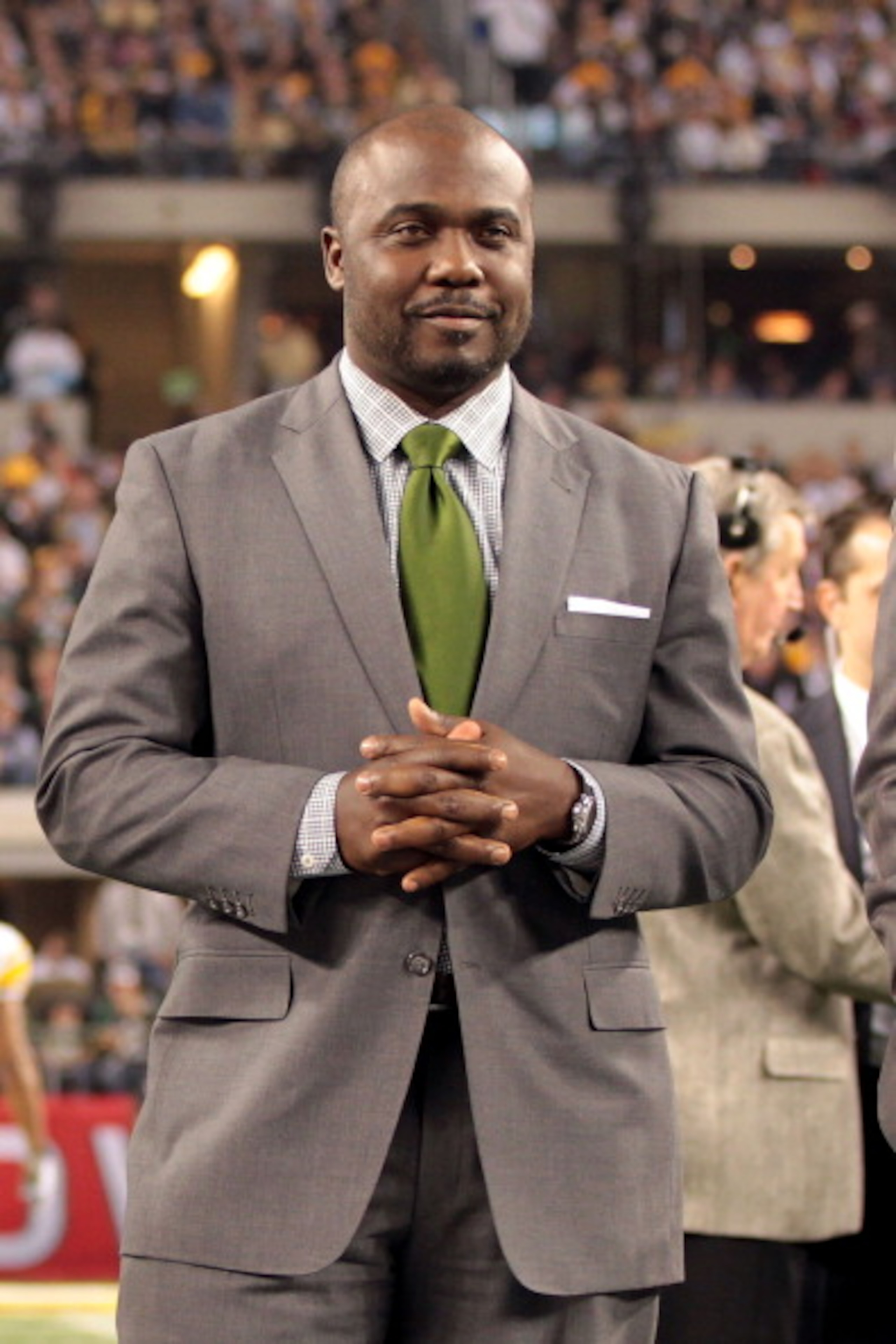 ARLINGTON, TX - FEBRUARY 06:  Pro Football Hall of Fame Class of 2011 member Marshall Faulk stands on the field prior to Super Bowl XLV between the Pittsburgh Steelers and the Green Bay Packers at Cowboys Stadium on February 6, 2011 in Arlington, Texas.  