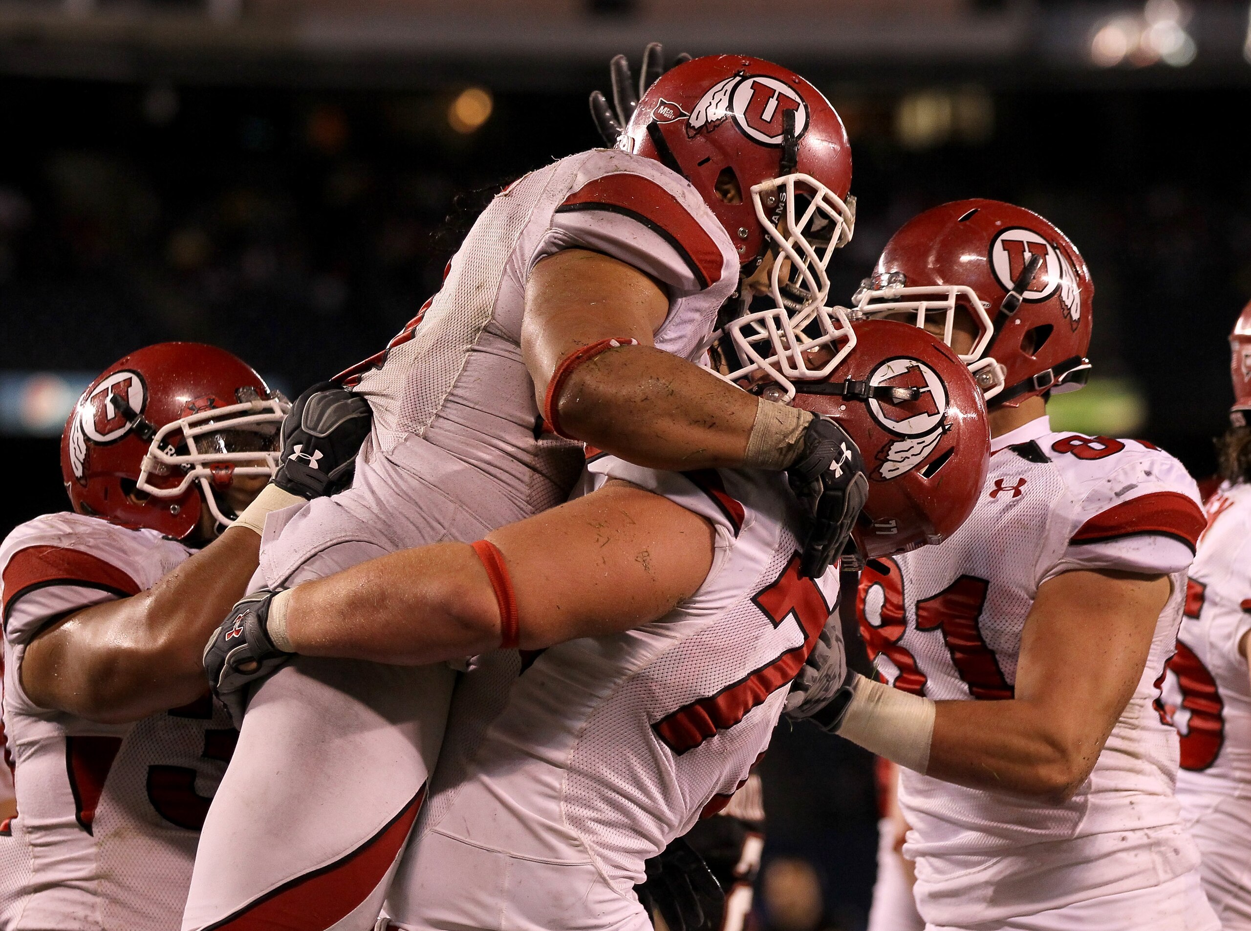 SAN DIEGO - NOVEMBER 20: Running back Matt Asiata #4 and center Zane Taylor #77 of the Utah Utes celebrate Asiata's one yard touchdown run against the San Diego State Aztecs in the fourth quarter at Qualcomm Stadium on November 20, 2010 in San Diego, Ca SAN DIEGO - NOVEMBER 20: Running back Matt Asiata #4 and center Zane Taylor #77 of the Utah Utes celebrate Asiata's one yard touchdown run against the San Diego State Aztecs in the fourth quarter at Qualcomm Stadium on November 20, 2010 in San Diego, Ca
