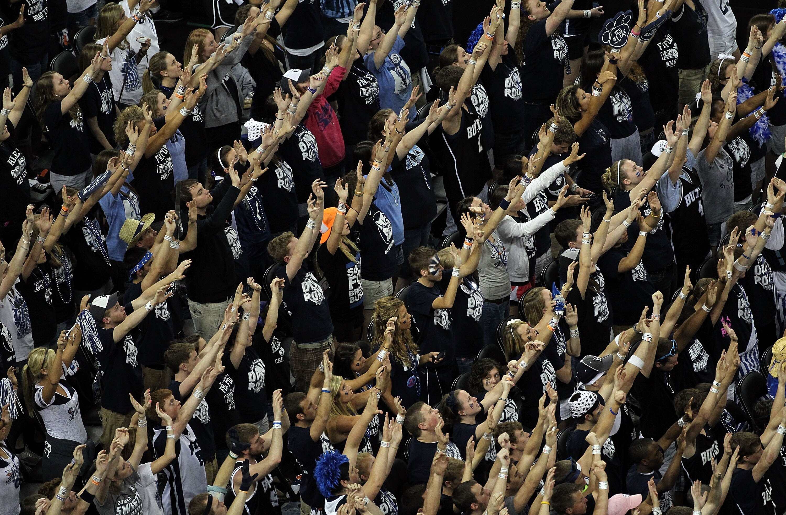 HOUSTON, TX - APRIL 04:  Fans of the Butler Bulldogs raise their hands during the National Championship Game of the 2011 NCAA Division I Men's Basketball Tournament at Reliant Stadium on April 4, 2011 in Houston, Texas.  (Photo by Andy Lyons/Getty Images)