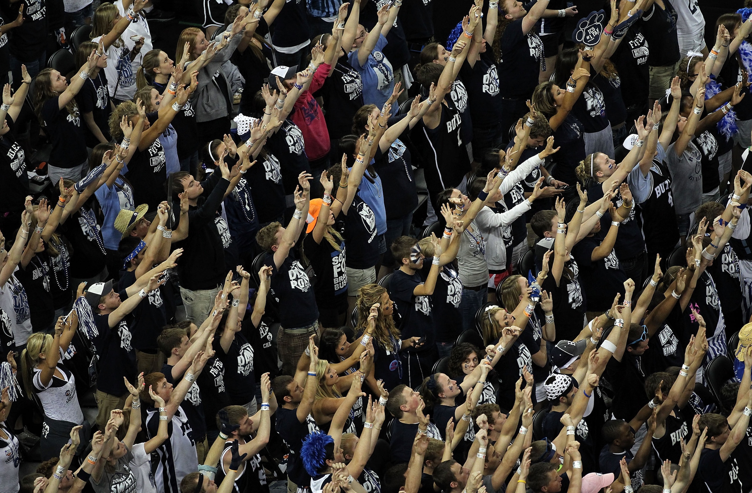 HOUSTON, TX - APRIL 04:  Fans of the Butler Bulldogs raise their hands during the National Championship Game of the 2011 NCAA Division I Men's Basketball Tournament at Reliant Stadium on April 4, 2011 in Houston, Texas.  (Photo by Andy Lyons/Getty Images)