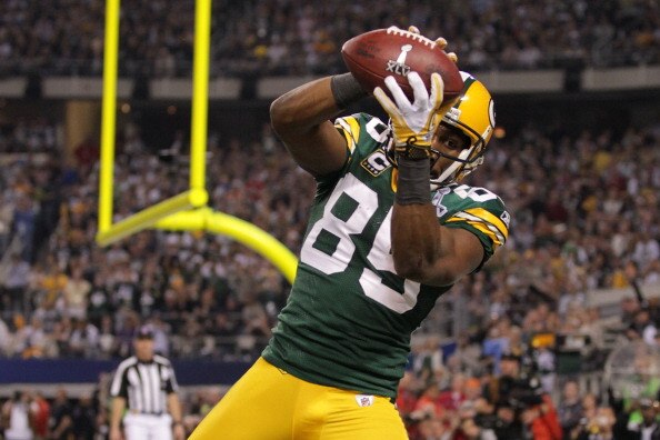 ARLINGTON, TX - FEBRUARY 06:  Greg Jennings #85 of the Green Bay Packers catches a a fourth quarter touchdown pass against the Pittsburgh Steelers  during Super Bowl XLV at Cowboys Stadium on February 6, 2011 in Arlington, Texas.  (Photo by Doug Pensinger