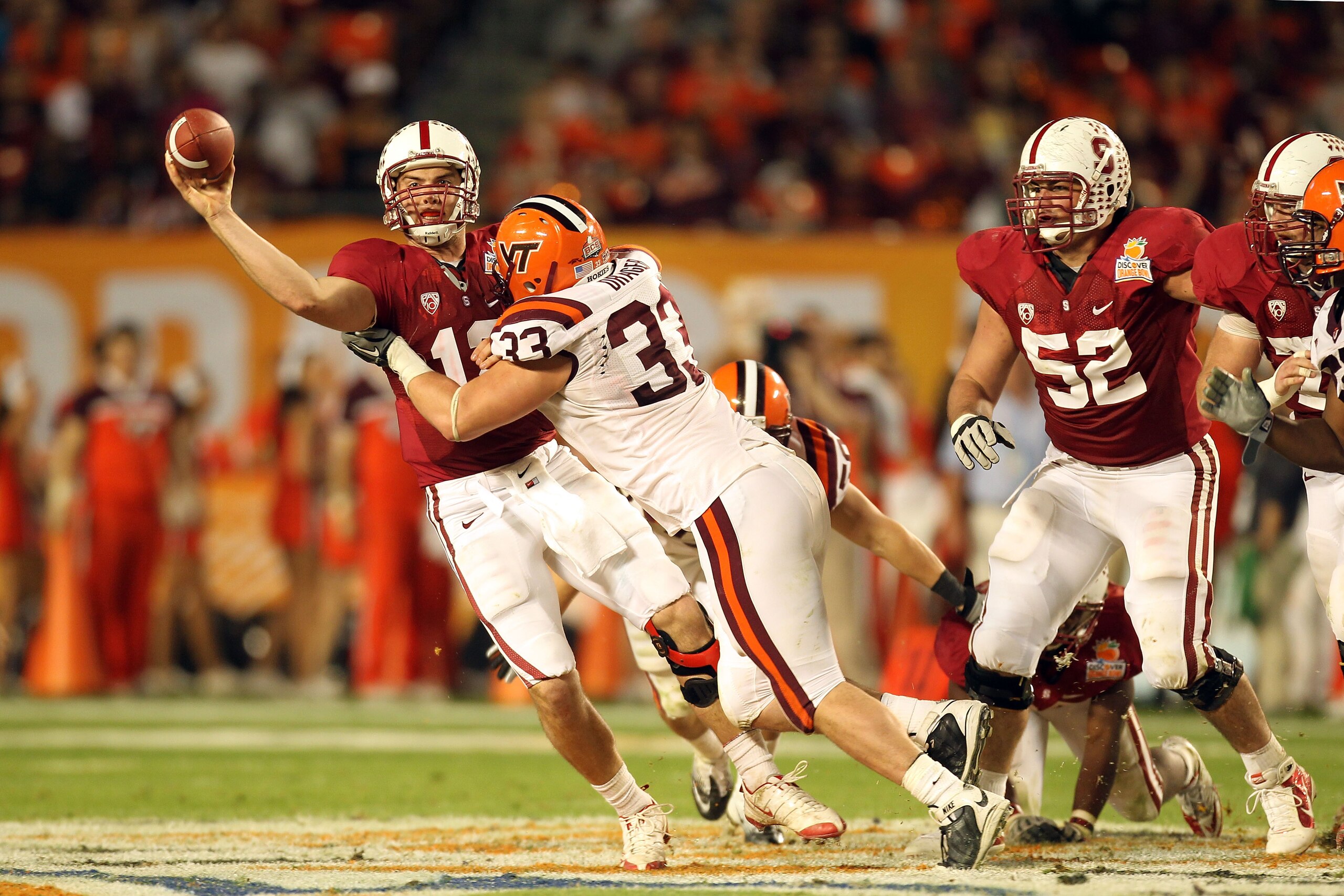 MIAMI, FL - JANUARY 03:  Andrew Luck #12 of the Stanford Cardinal throws a pass under pressure from Chris Drager #33 of the Virginia Tech Hokies during the 2011 Discover Orange Bowl at Sun Life Stadium on January 3, 2011 in Miami, Florida. Stanford won 40