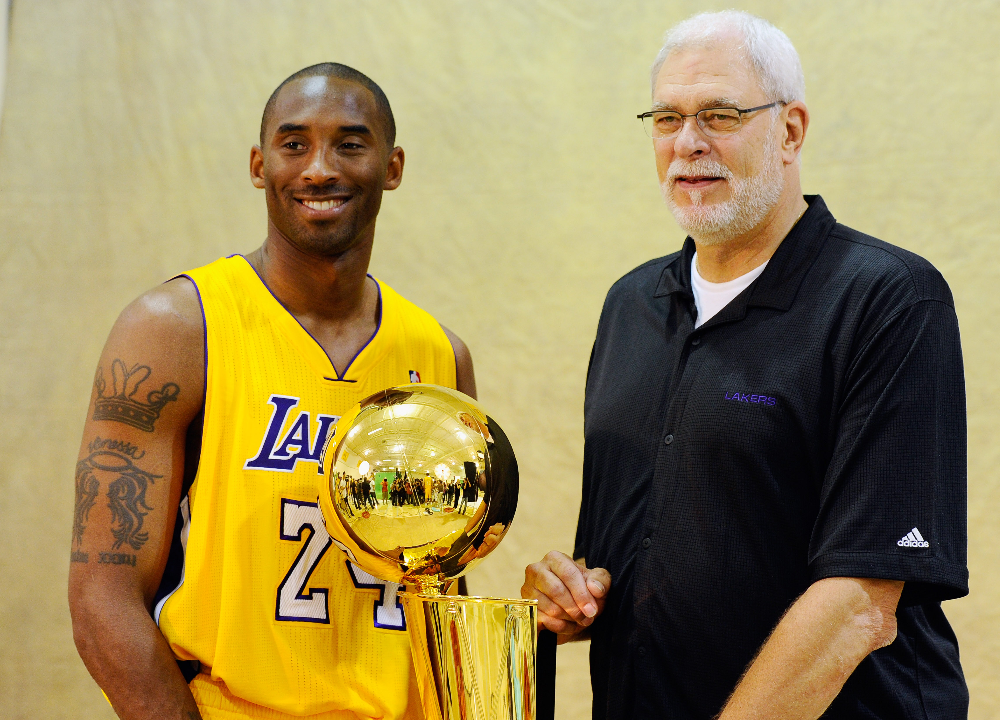 EL SEGUNDO, CA - SEPTEMBER 25:  Kobe Bryant #24 and head coach Phil Jackson of the Los Angeles Lakers pose with NBA Finals Larry O'Brien Championship Trophy during  Media Day at the Toyota Center on September 25, 2010 in El Segundo, California. NOTE TO US