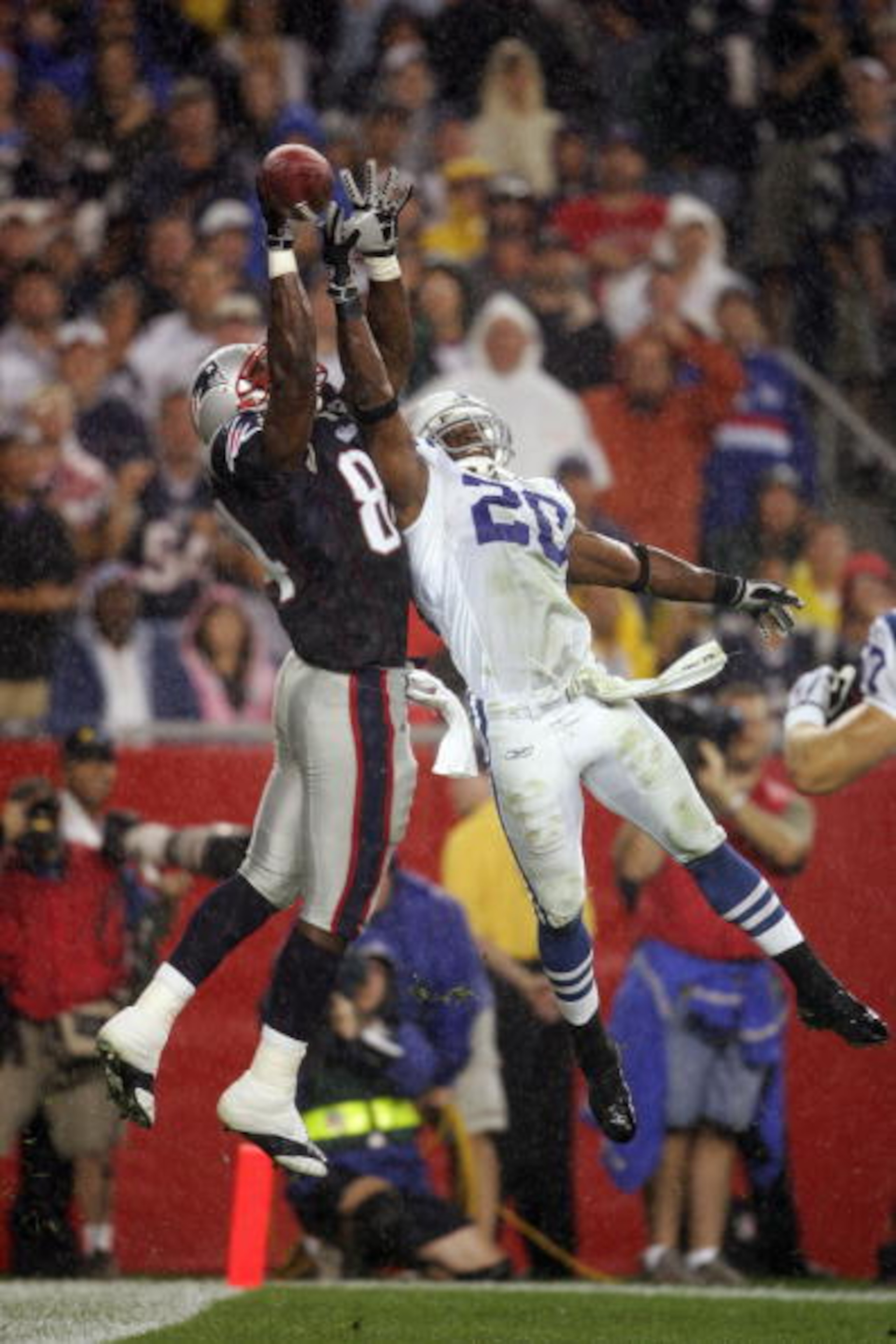 FOXBOROUGH, MA - SEPTEMBER 9:  Ben Watson #84 of the New England Patriots and Mike Doss #20 of the  the Indianapolis Colts jump for a ball in the end zone during the NFL game at Gillette Stadium on September 9, 2004 in Foxborough, Massachusetts.  The Patr