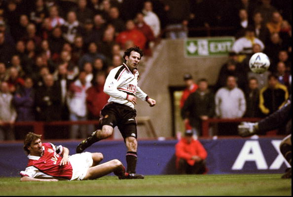 14 Apr 1999:  Ryan Giggs of Manchester United beats the despairing lunge of Tony Adams of Arsenal to drive the ball past David Seaman to score the winner in the FA Cup Semi Final match played at Villa Park in Birmingham. Manchester United won the game 2-1