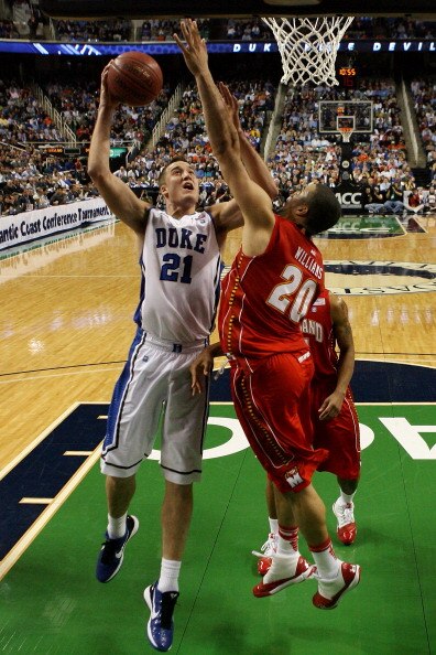 GREENSBORO, NC - MARCH 11:  Miles Plumlee #21 of the Duke Blue Devils shoots against Jordan Williams #20 of the Maryland Terrapins during the second half in the quarterfinals of the 2011 ACC men's basketball tournament at the Greensboro Coliseum on March
