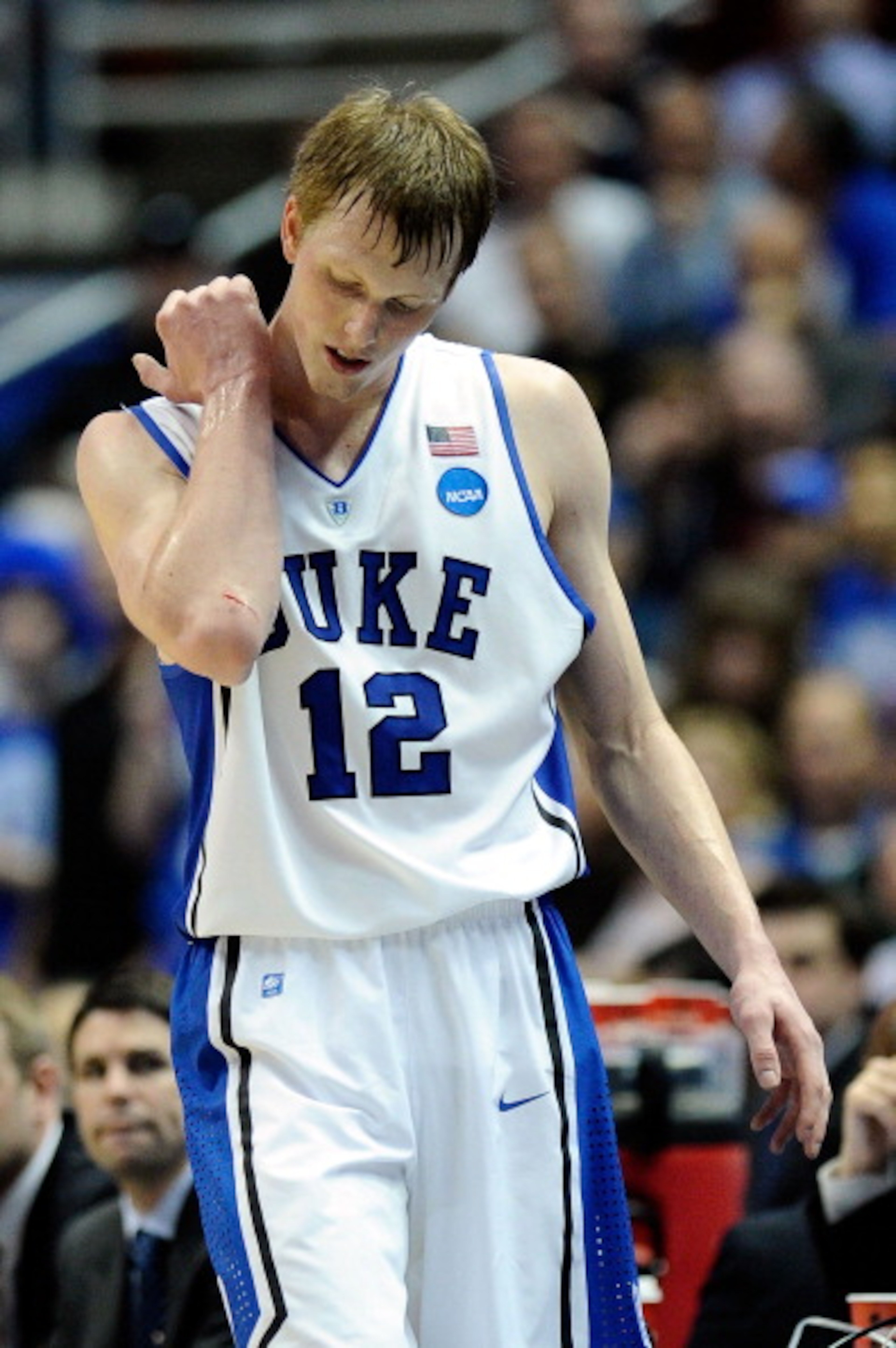 ANAHEIM, CA - MARCH 24:  Kyle Singler #12 of the Duke Blue Devils looks at a cut on his elbow while playing against the Arizona Wildcats during the west regional semifinal of the 2011 NCAA men's basketball tournament at the Honda Center on March 24, 2011