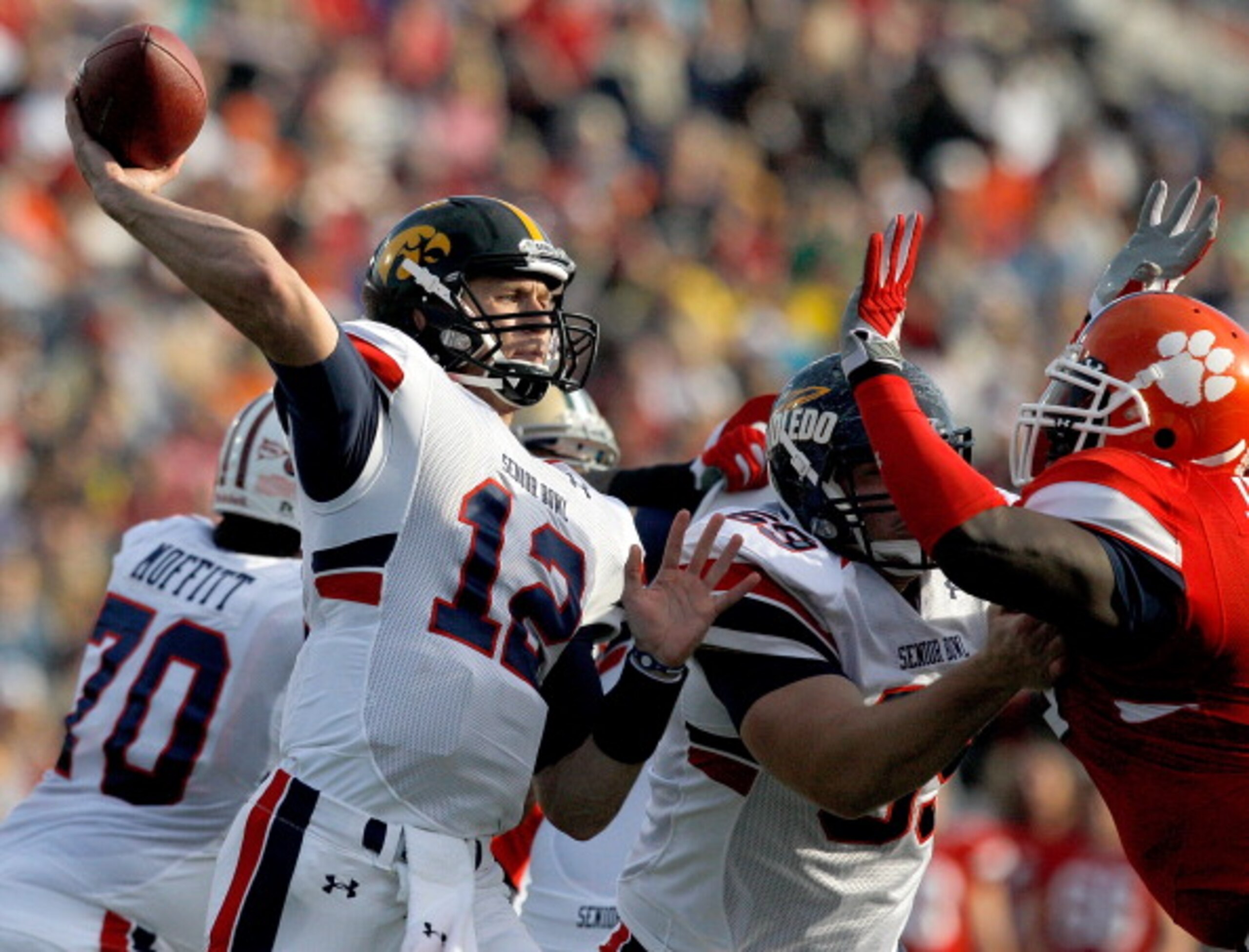 MOBILE, AL - JANUARY 29: Quarterback Ricky Stanzi #12 of the North Team passes over South Team defenders during second quarter of the Under Armour Senior Bowl on January 29, 2011 at Ladd Peebles Stadium in Mobile, Alabama.  (Photo by Sean Gardner/Getty Im