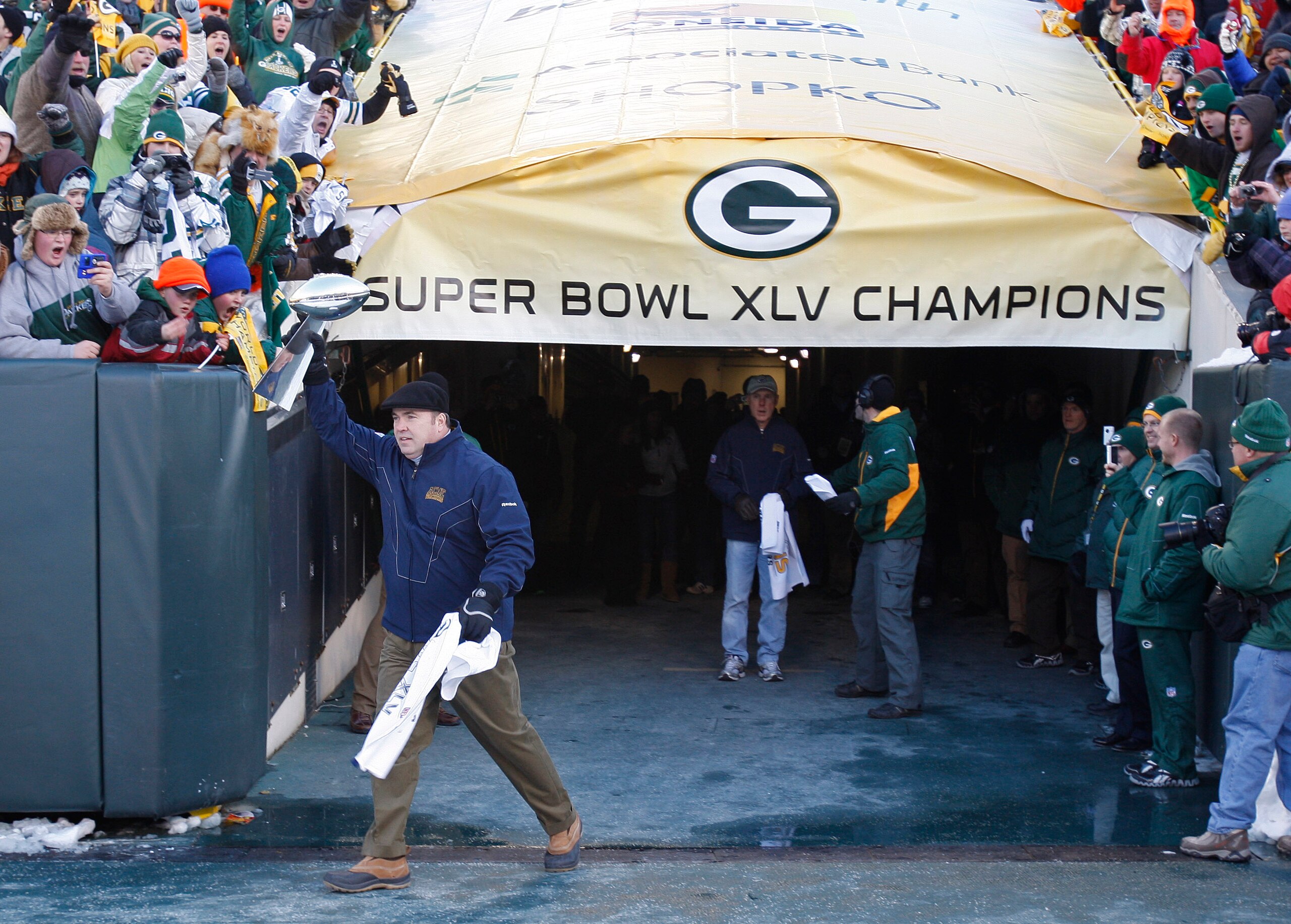 GREEN BAY, WI - FEBRUARY 08: Green Bay Packers head coach Mike McCarthy carries the Lombardi Trophy onto Lambeau Field during the Packers victory ceremony on February 8, 2011 in Green Bay, Wisconsin.  (Photo by Matt Ludtke/Getty Images)