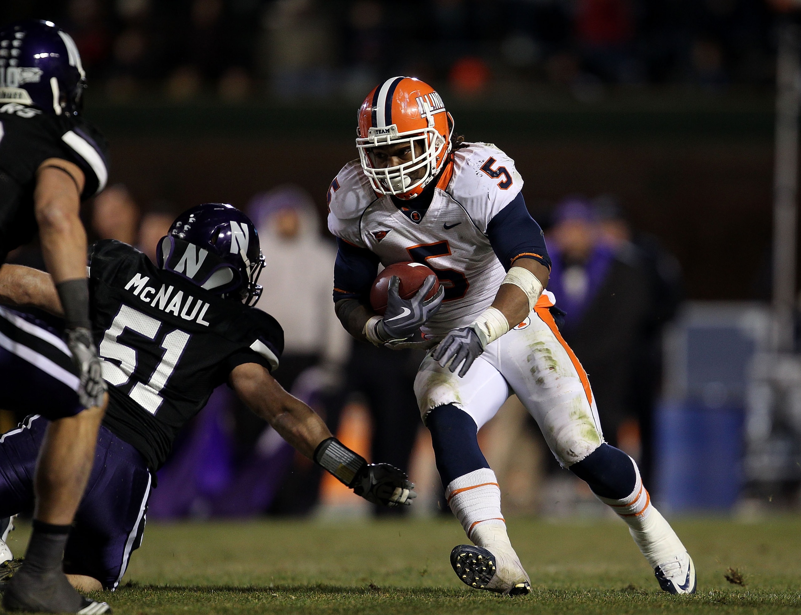 CHICAGO - NOVEMBER 20: Mikel Leshoure #5 of the Illinois Fighting Illini runs past Bryce McNaul #51 of the Northwestern Wildcats on his way to a 339 yard rushing performance during a game played at Wrigley Field on November 20, 2010 in Chicago, Illinois. CHICAGO - NOVEMBER 20: Mikel Leshoure #5 of the Illinois Fighting Illini runs past Bryce McNaul #51 of the Northwestern Wildcats on his way to a 339 yard rushing performance during a game played at Wrigley Field on November 20, 2010 in Chicago, Illinois.