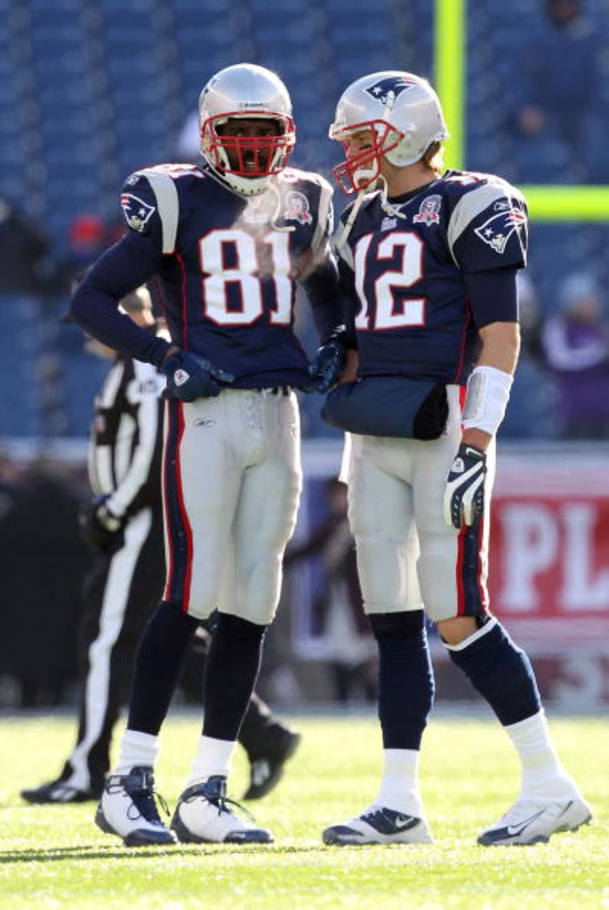 FOXBORO, MA - JANUARY 10: (L-R) Randy Moss #81 and Tom Brady #12 of the New England Patriots talk on the field during warm ups against the Baltimore Ravens during the 2010 AFC wild-card playoff game at Gillette Stadium on January 10, 2010 in Foxboro, Mas FOXBORO, MA - JANUARY 10: (L-R) Randy Moss #81 and Tom Brady #12 of the New England Patriots talk on the field during warm ups against the Baltimore Ravens during the 2010 AFC wild-card playoff game at Gillette Stadium on January 10, 2010 in Foxboro, Mas