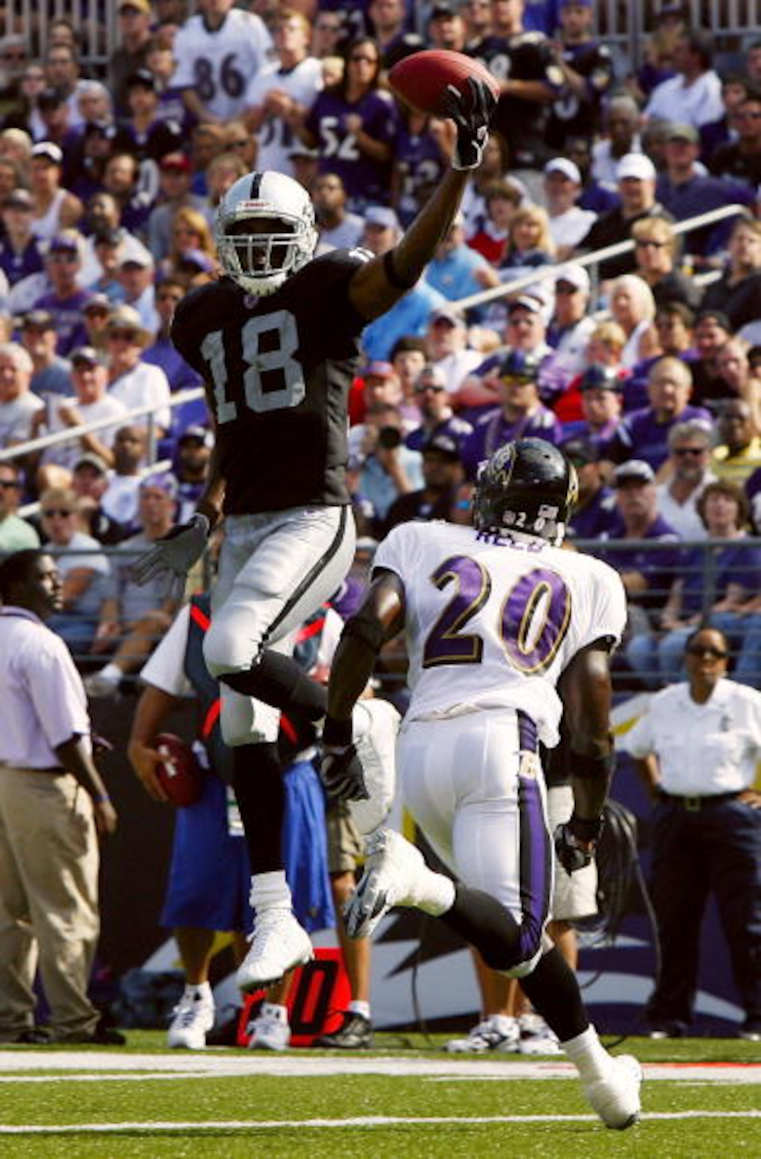 BALTIMORE - SEPTEMBER 17: Randy Moss #18 of the Oakland Raiders leaps for a pass over Baltimore Ravens safety Ed Reed #20 in fourth quarter action on September 17, 2006 at M&T Bank Stadium in Baltimore, Maryland. The Ravens defeated the Raiders 28-6. (P BALTIMORE - SEPTEMBER 17: Randy Moss #18 of the Oakland Raiders leaps for a pass over Baltimore Ravens safety Ed Reed #20 in fourth quarter action on September 17, 2006 at M&T Bank Stadium in Baltimore, Maryland. The Ravens defeated the Raiders 28-6. (P