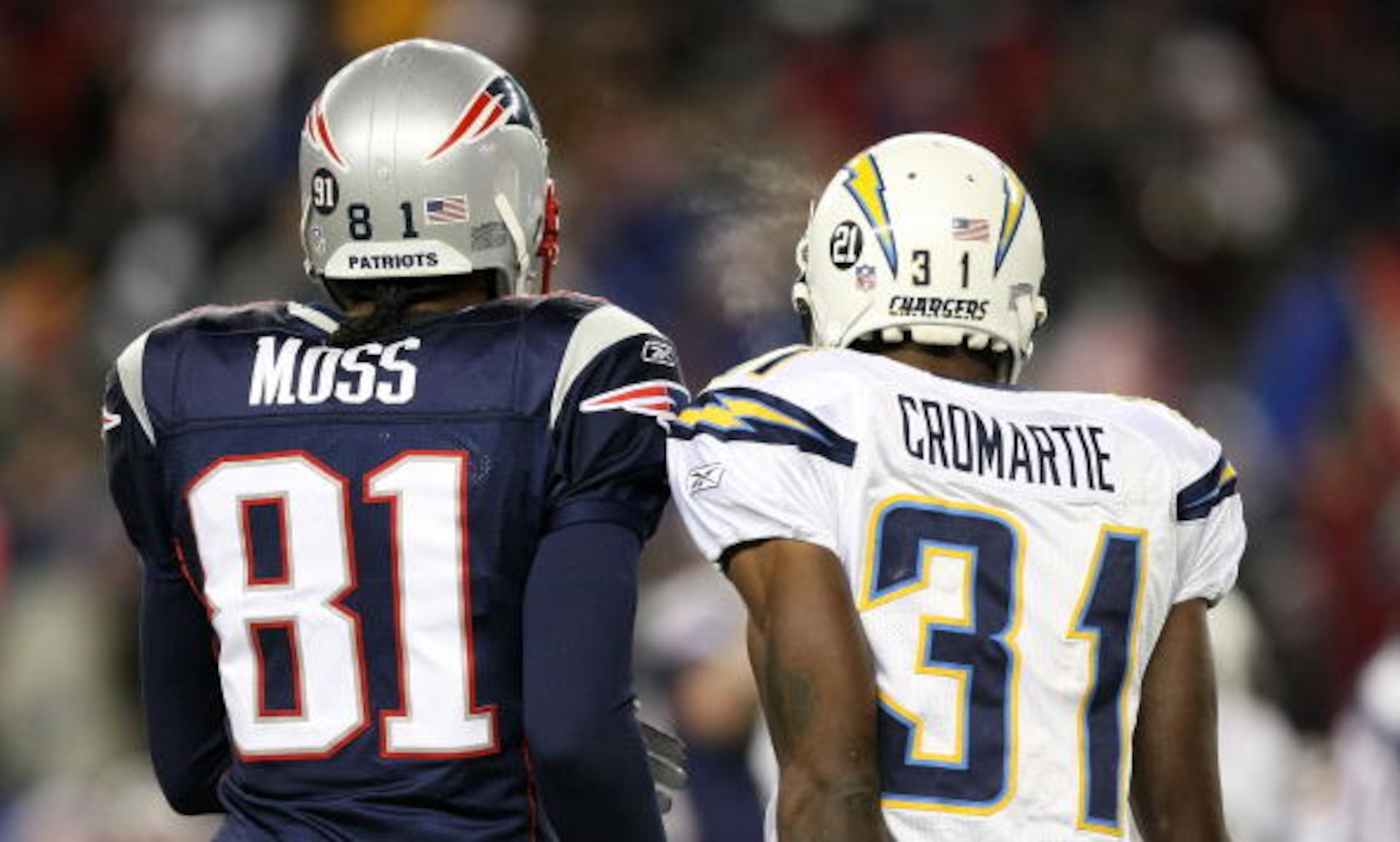 FOXBORO, MA - JANUARY 20: (L-R) Randy Moss #81 of the New England Patriots stands on the field next to Antonio Cromartie #31 of the San Diego Chargers during the AFC Championship Game on January 20, 2008 at Gillette Stadium in Foxboro, Massachusetts. The FOXBORO, MA - JANUARY 20: (L-R) Randy Moss #81 of the New England Patriots stands on the field next to Antonio Cromartie #31 of the San Diego Chargers during the AFC Championship Game on January 20, 2008 at Gillette Stadium in Foxboro, Massachusetts. The