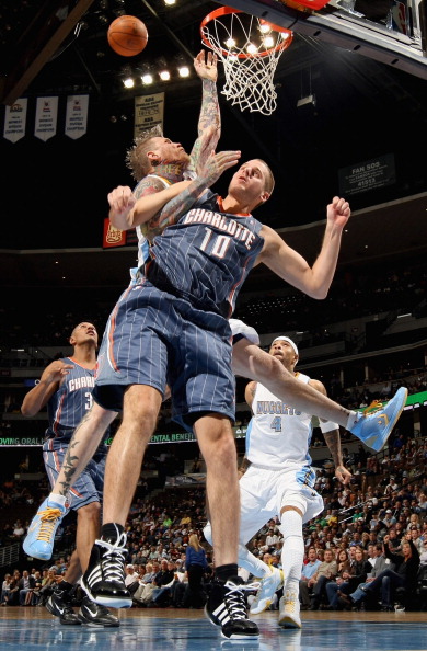 DENVER, CO - MARCH 02:  Chris Andersen #11 of the Denver Nuggets is fouled by Joel Pryzbilla #10 of the Charlotte Bobcats at the Pepsi Center on March 2, 2011 in Denver, Colorado. NOTE TO USER: User expressly acknowledges and agrees that, by downloading a