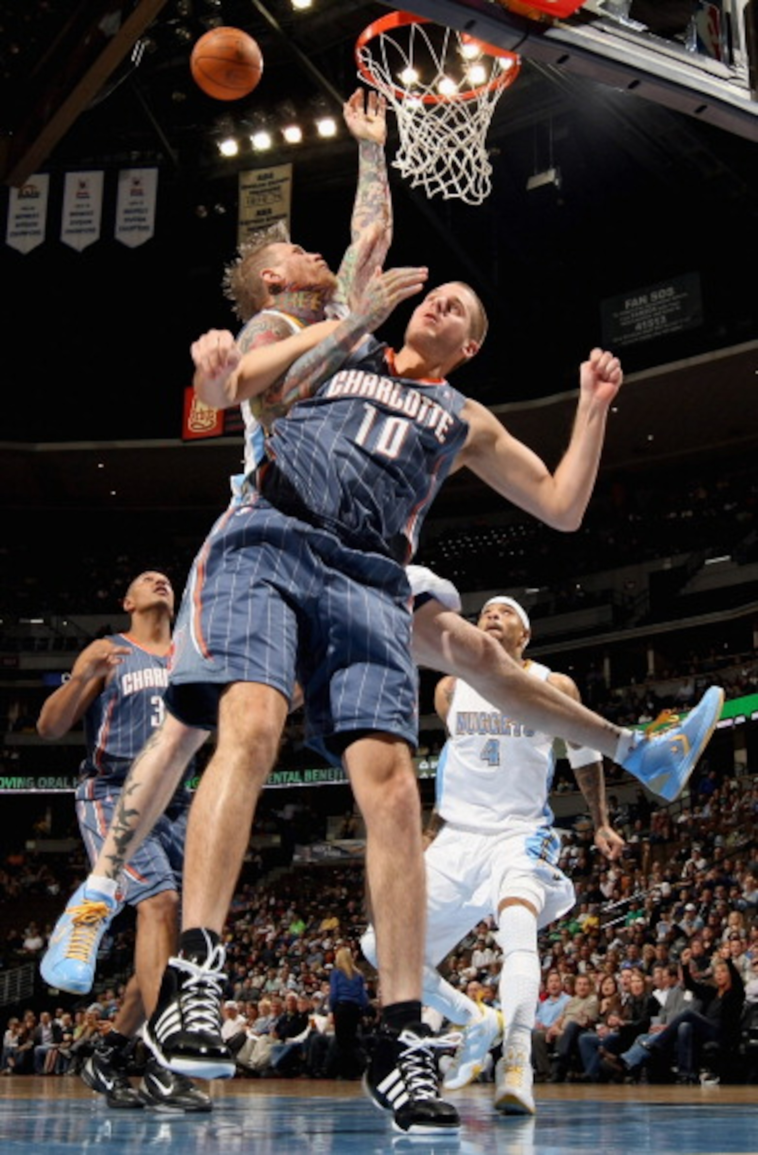 DENVER, CO - MARCH 02: Chris Andersen #11 of the Denver Nuggets is fouled by Joel Pryzbilla #10 of the Charlotte Bobcats at the Pepsi Center on March 2, 2011 in Denver, Colorado. NOTE TO USER: User expressly acknowledges and agrees that, by downloading a DENVER, CO - MARCH 02: Chris Andersen #11 of the Denver Nuggets is fouled by Joel Pryzbilla #10 of the Charlotte Bobcats at the Pepsi Center on March 2, 2011 in Denver, Colorado. NOTE TO USER: User expressly acknowledges and agrees that, by downloading a