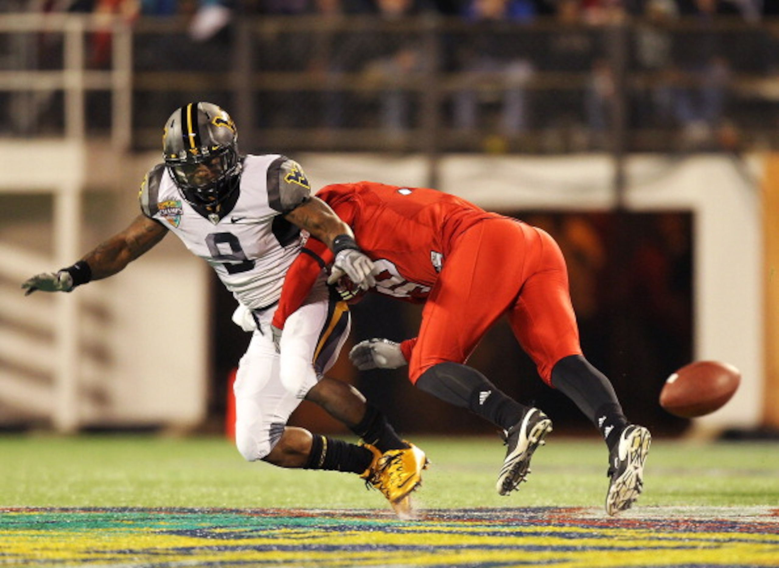 ORLANDO, FL - DECEMBER 28:  Jock Sanders #9 of the West Virginia Mountineers misses a catch defended by Nate Irving #56 of the North Carolina State Wolfpack during the Champs Sports Bowl at Florida Citrus Bowl Stadium on December 28, 2010 in Orlando, Flor