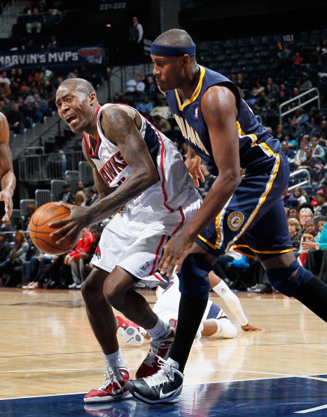ATLANTA, GA - DECEMBER 11:  Jamal Crawford #11 of the Atlanta Hawks draws a foul from James Posey #41 of the Indiana Pacers at Philips Arena on December 11, 2010 in Atlanta, Georgia.  NOTE TO USER: User expressly acknowledges and agrees that, by downloadi