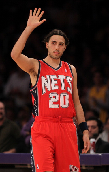 LOS ANGELES, CA - JANUARY 14:  Sasha Vujacic #20 of the New Jersey Nets waves to the crowd as he enters the game in his first return since being traded by the Los Angeles Lakers at Staples Center on January 14, 2011 in Los Angeles, California.  NOTE TO US
