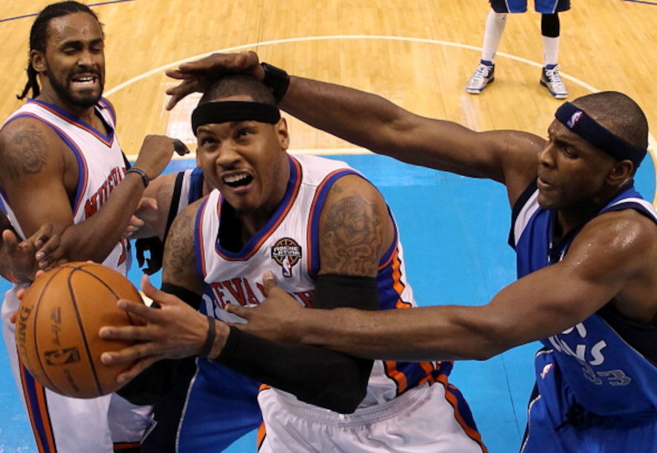 DALLAS, TX - MARCH 10: Forward Carmelo Anthony #7 of the New York Knicks is fouled by Brendan Haywood #33 of the Dallas Mavericks at American Airlines Center on March 10, 2011 in Dallas, Texas. NOTE TO USER: User expressly acknowledges and agrees that, DALLAS, TX - MARCH 10: Forward Carmelo Anthony #7 of the New York Knicks is fouled by Brendan Haywood #33 of the Dallas Mavericks at American Airlines Center on March 10, 2011 in Dallas, Texas. NOTE TO USER: User expressly acknowledges and agrees that,