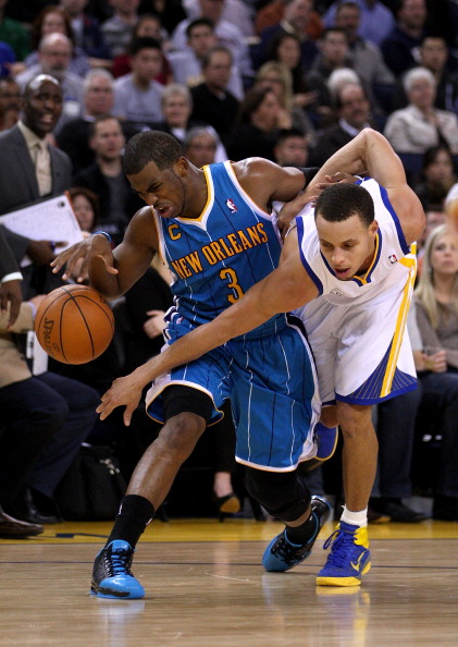 OAKLAND, CA - JANUARY 26:  Stephen Curry #30 of the Golden State Warriors fouls Chris Paul #3 of the New Orleans Hornets at Oracle Arena on January 26, 2011 in Oakland, California.  NOTE TO USER: User expressly acknowledges and agrees that, by downloading