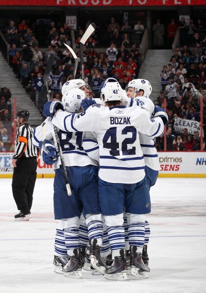 OTTAWA, CANADA - APRIL 2: Tyler Bozak #42 of the Toronto Maple Leafs celebrates his third period goal with team mates Phil Kessel #81Carl Gunnarsson #36 against the Ottawa Senators at Scotiabank Place on April 2, 2011 in Ottawa, Ontario, Canada.  (Photo b