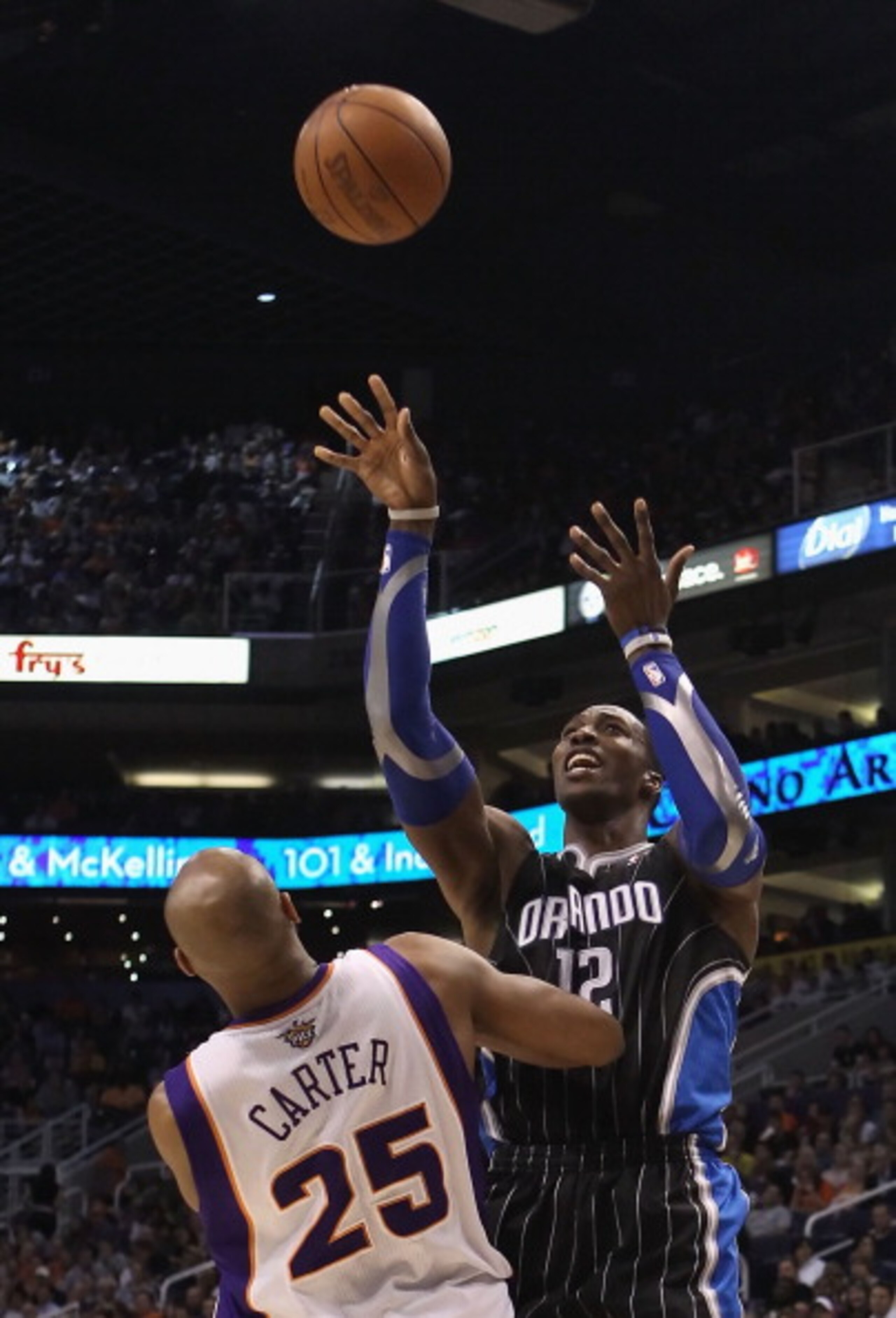 PHOENIX, AZ - MARCH 13:  Dwight Howard #12 of the Orlando Magic puts up a shot against the Phoenix Suns during the NBA game at US Airways Center on March 13, 2011 in Phoenix, Arizona. The Magic defeated the Suns 111-88. NOTE TO USER: User expressly acknow
