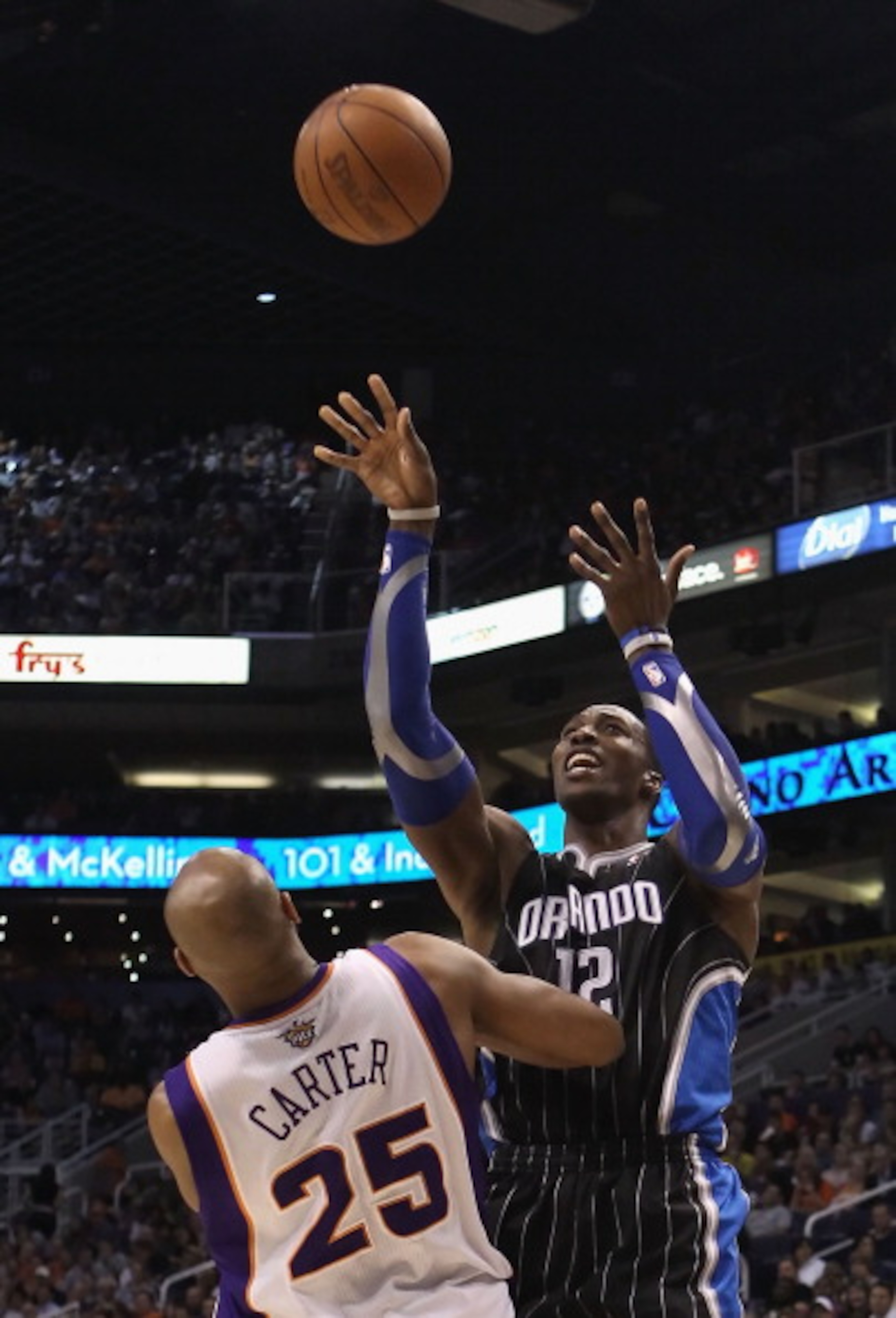 PHOENIX, AZ - MARCH 13:  Dwight Howard #12 of the Orlando Magic puts up a shot against the Phoenix Suns during the NBA game at US Airways Center on March 13, 2011 in Phoenix, Arizona. The Magic defeated the Suns 111-88. NOTE TO USER: User expressly acknow