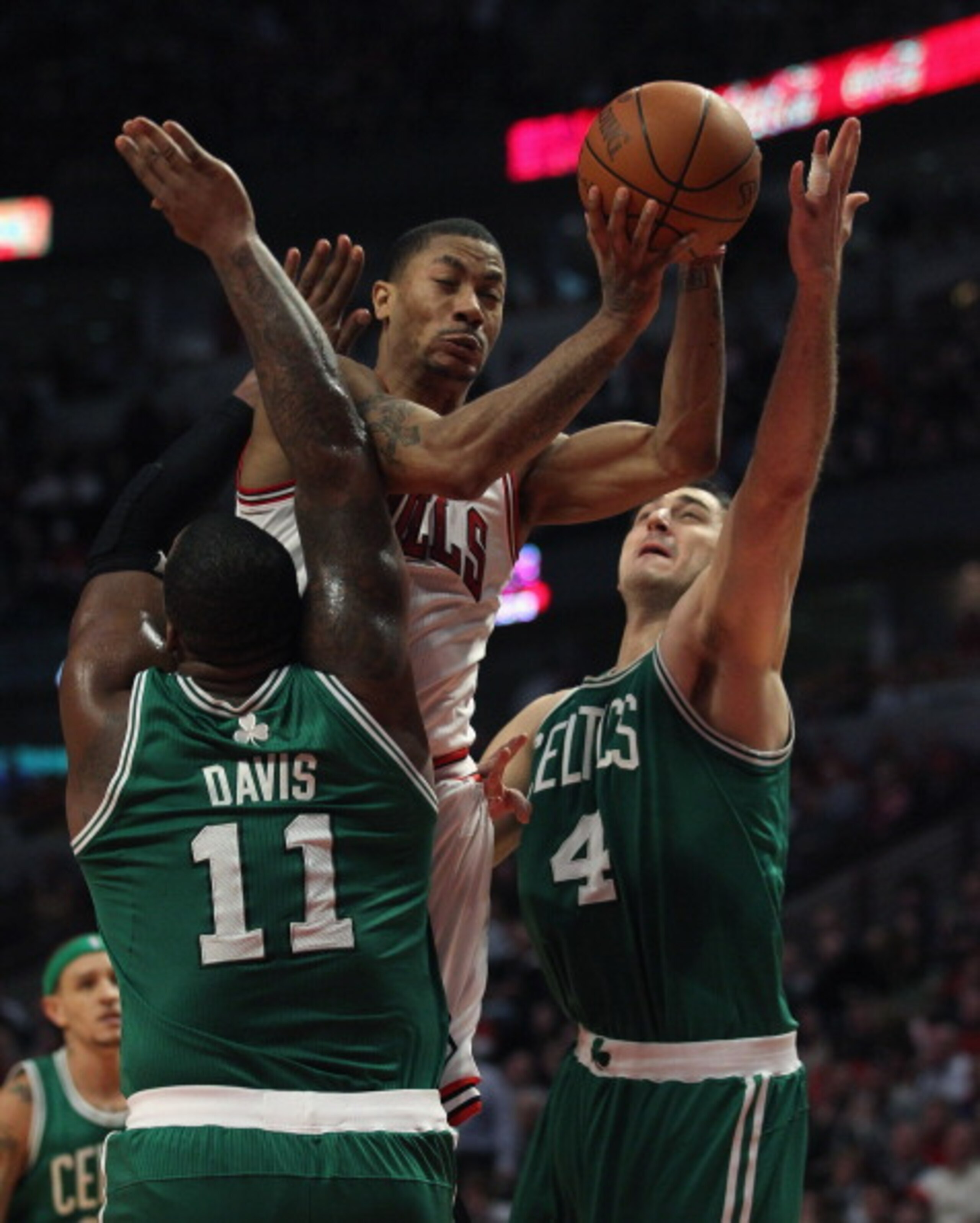CHICAGO, IL - APRIL 07: Derrick Rose #1 of the Chicago Bulls is called for a charge as he attempts to drive against Glen Davis #11 and Nenad Krstic #4 of the Boston Celtics at United Center on April 7, 2011 in Chicago, Illinois. The Bulls defeated the Cel