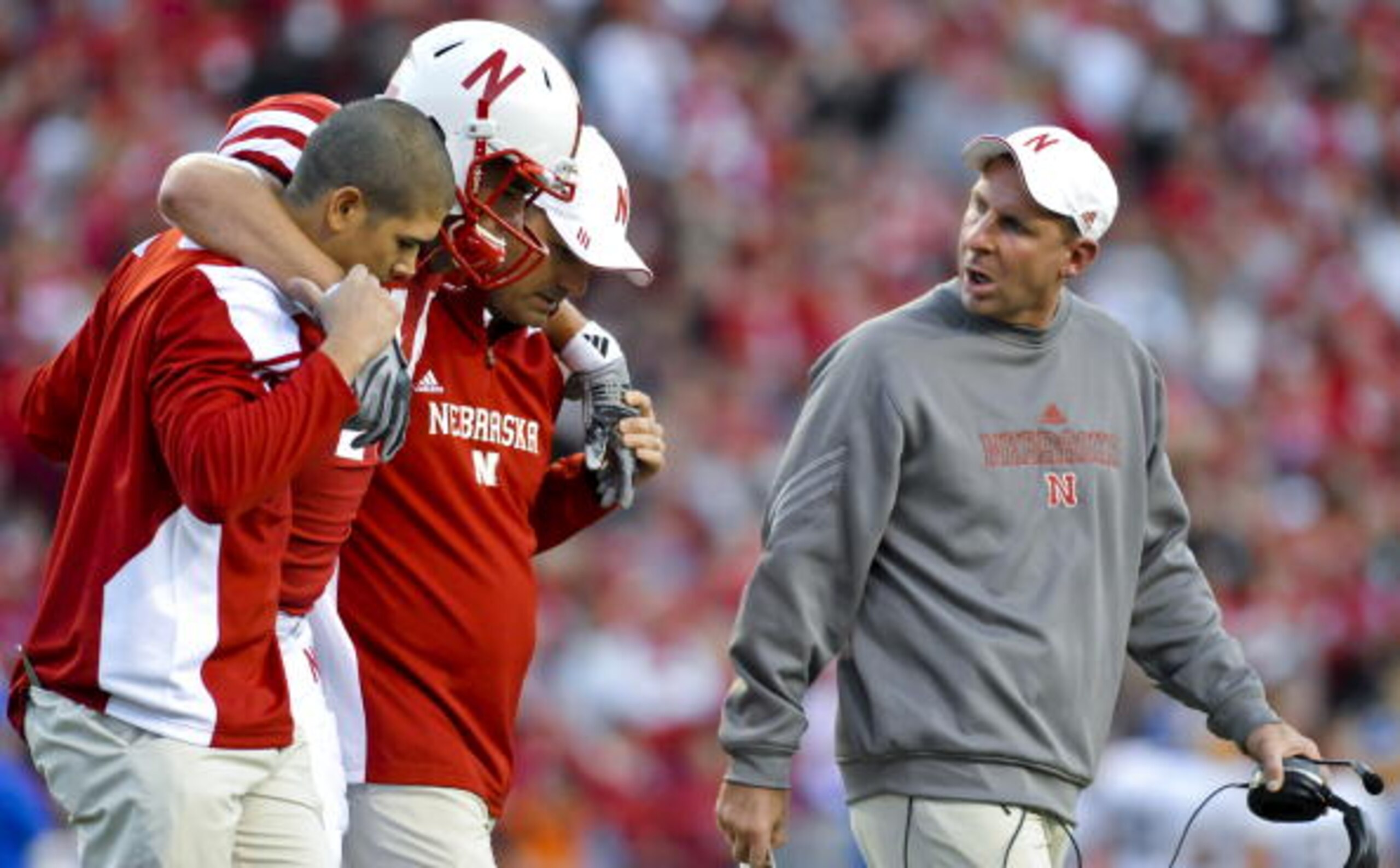LINCOLN, NEBRASKA - SEPTEMBER 25: Nebraksa Cornhusker head coach Bo Pelini (R) checks on injured Nebraska Cornhuskers tight end Mike McNeill #44 their game against the South Dakota State Jackrabbits at Memorial Stadium on September 25, 2010 in Lincoln, Ne